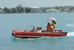 Slim Aarons, Sea Drive. A drive in an Amphicar across the harbour at Nassau 1967