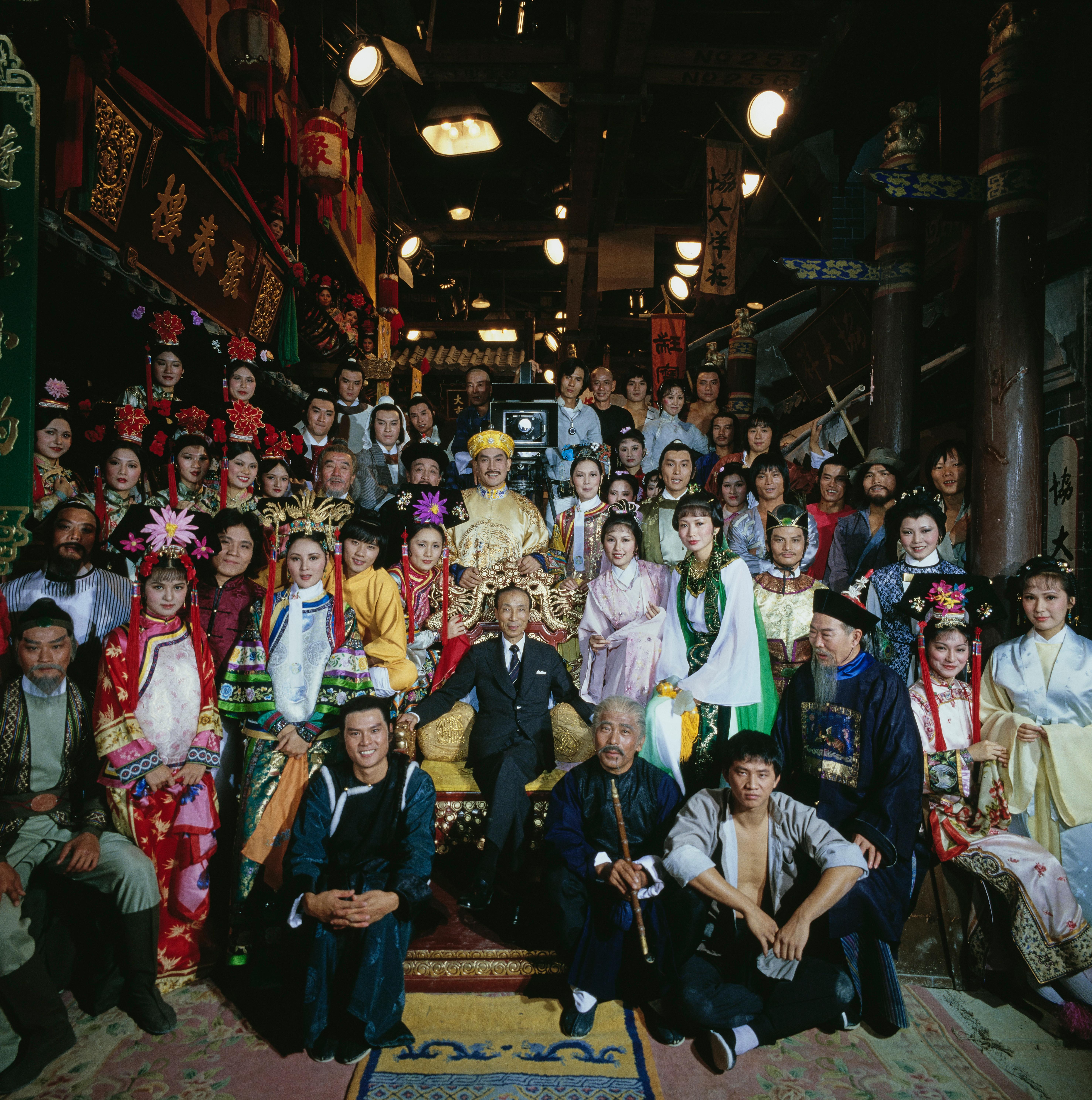 Slim Aarons Color Photograph - Sir Run Run Shaw surrounded by the stars of Hong Kong cinema