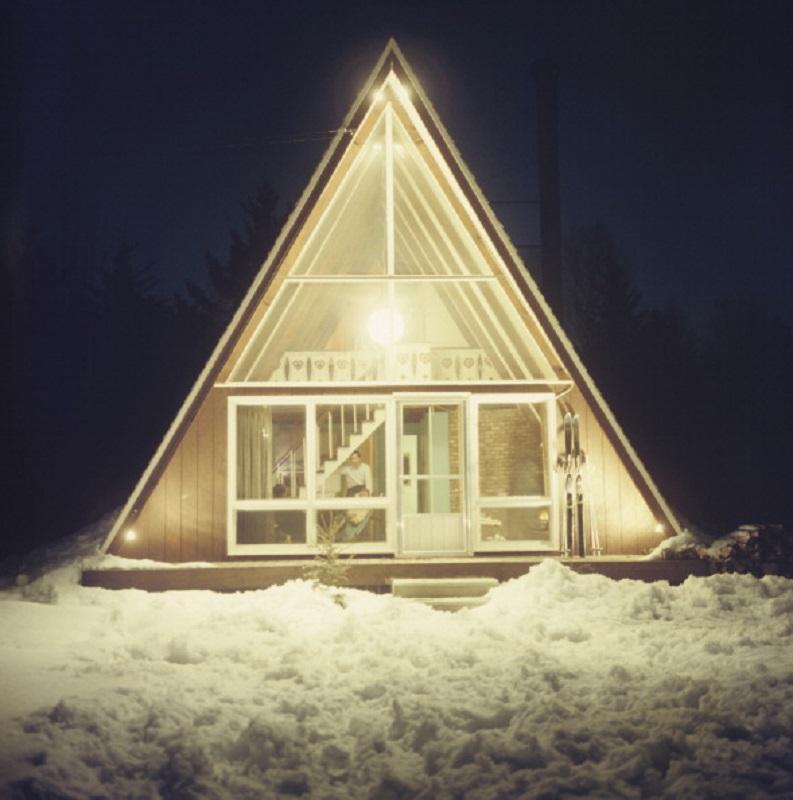 'Skaal House In Stowe' 1962 Slim Aarons Limited Estate Edition Print 

The glass-fronted triangular Skaal House, lit up at night, in the Stowe Mountain ski resort in Stowe, Vermont, 1962. A pair of skis leaning against the wall beside the door.