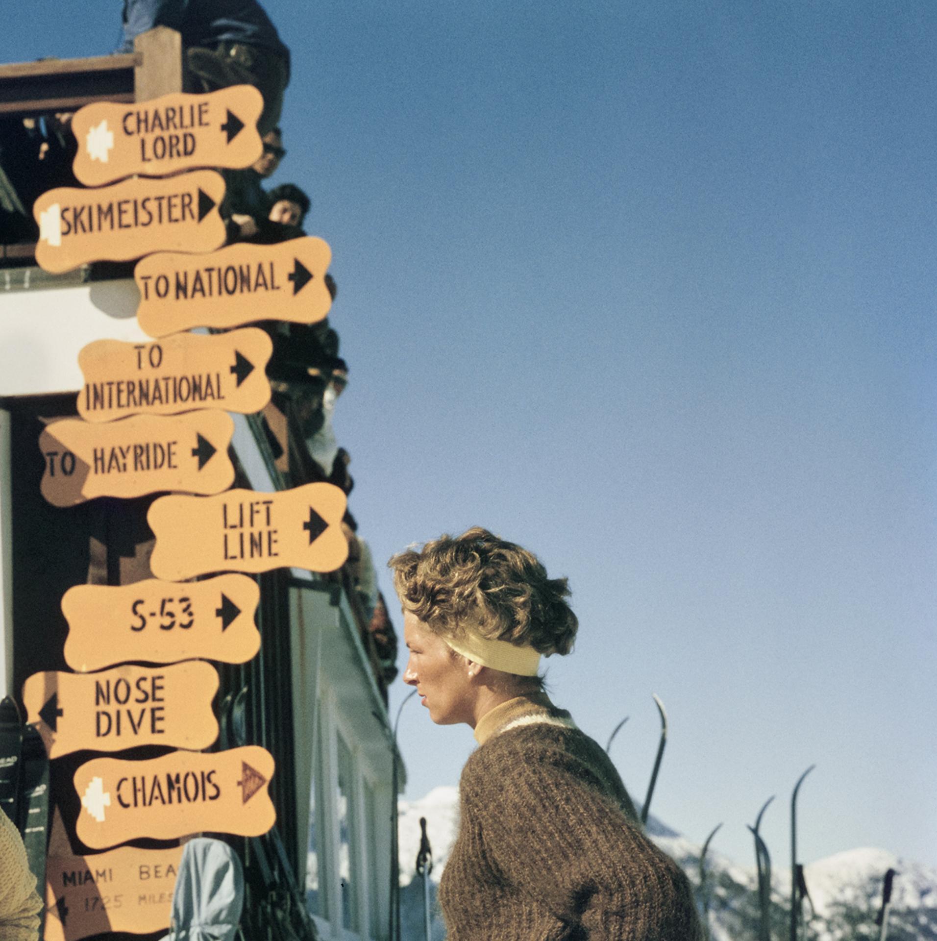 Skiing in Stowe, Vermont, Estate Edition, Winter Landscape Photograph

This 1960s winter landscape photograph, captured by society photographer Slim Aarons, features two women in knitwear, leaning on ski sticks, while standing in the Stowe Mountain