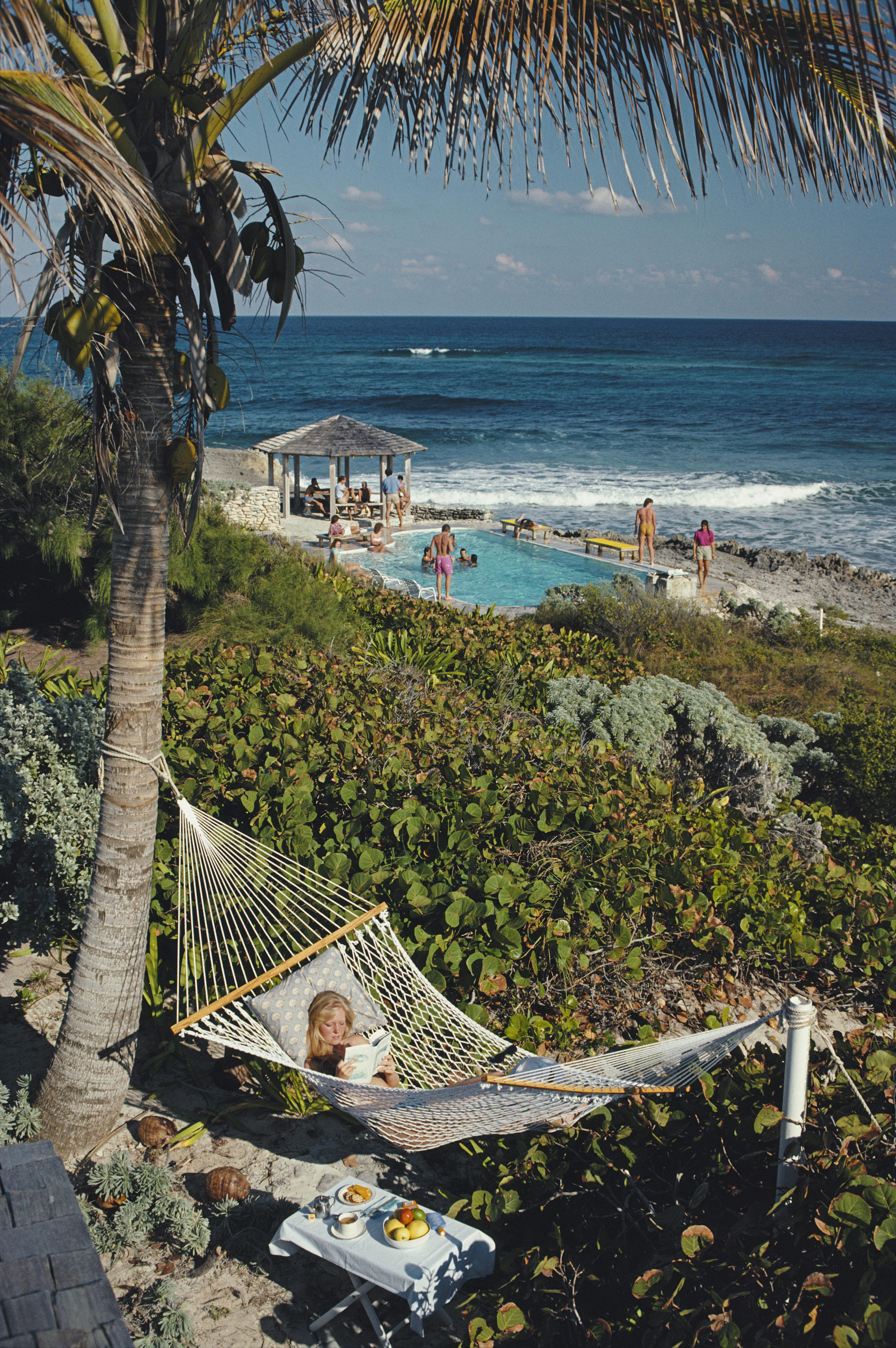 Slim Aarons
Abaco Holiday
1986 (printed later)
Chromogenic Lambda print
Estate stamped and hand numbered edition of 150 with certificate of authenticity from the estate.

College student Jan Woods relaxes in a hammock at the Abaco Inn on Elbow Cay,