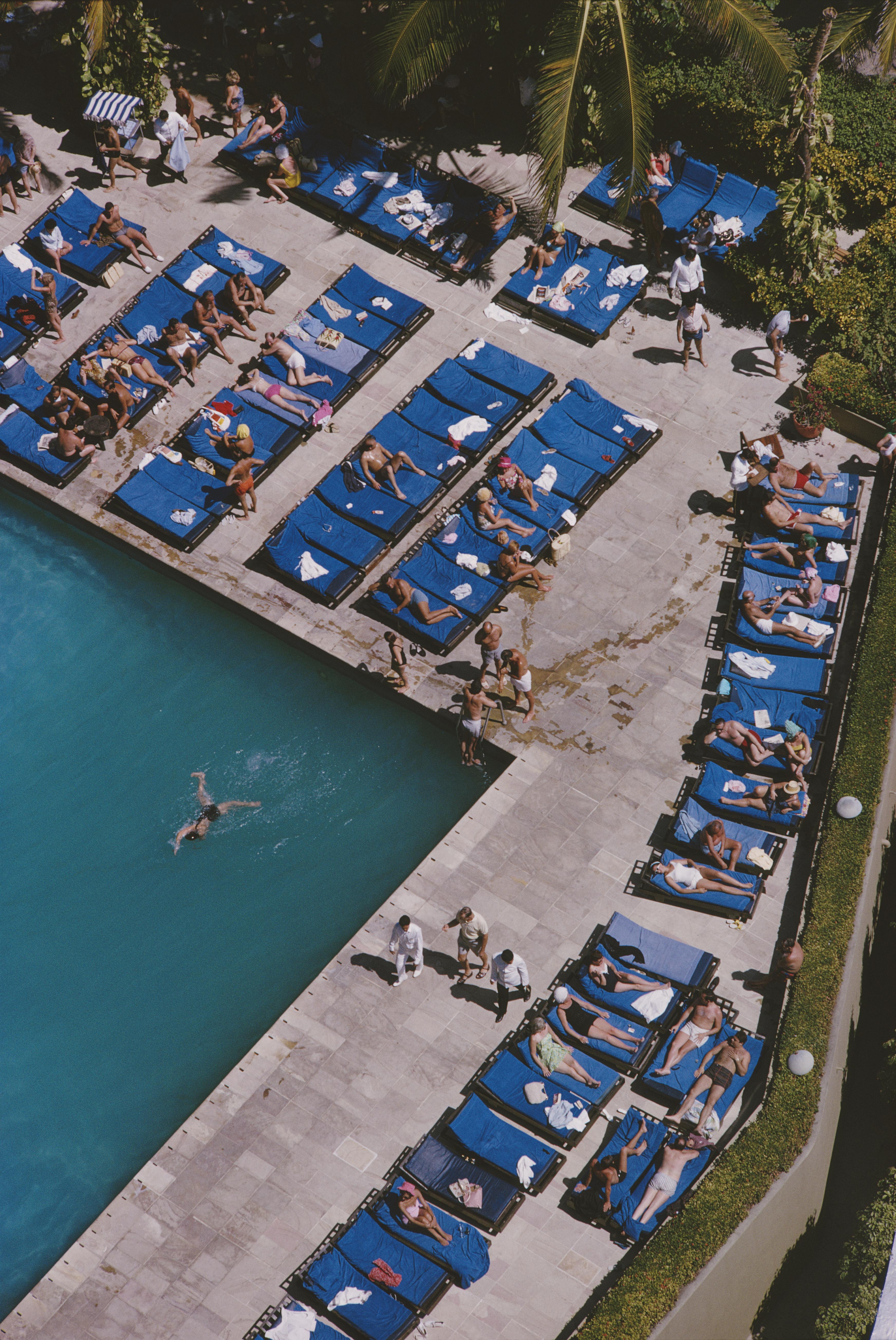 Slim Aarons
Acapulco Holiday, 1966
C print 
Estate stamped and numbered edition of 150 
with Certificate of authenticity

Deckchairs lined up beside a swimming pool in Acapulco, February 1966. 

Slim Aarons (1916-2006) worked mainly for society