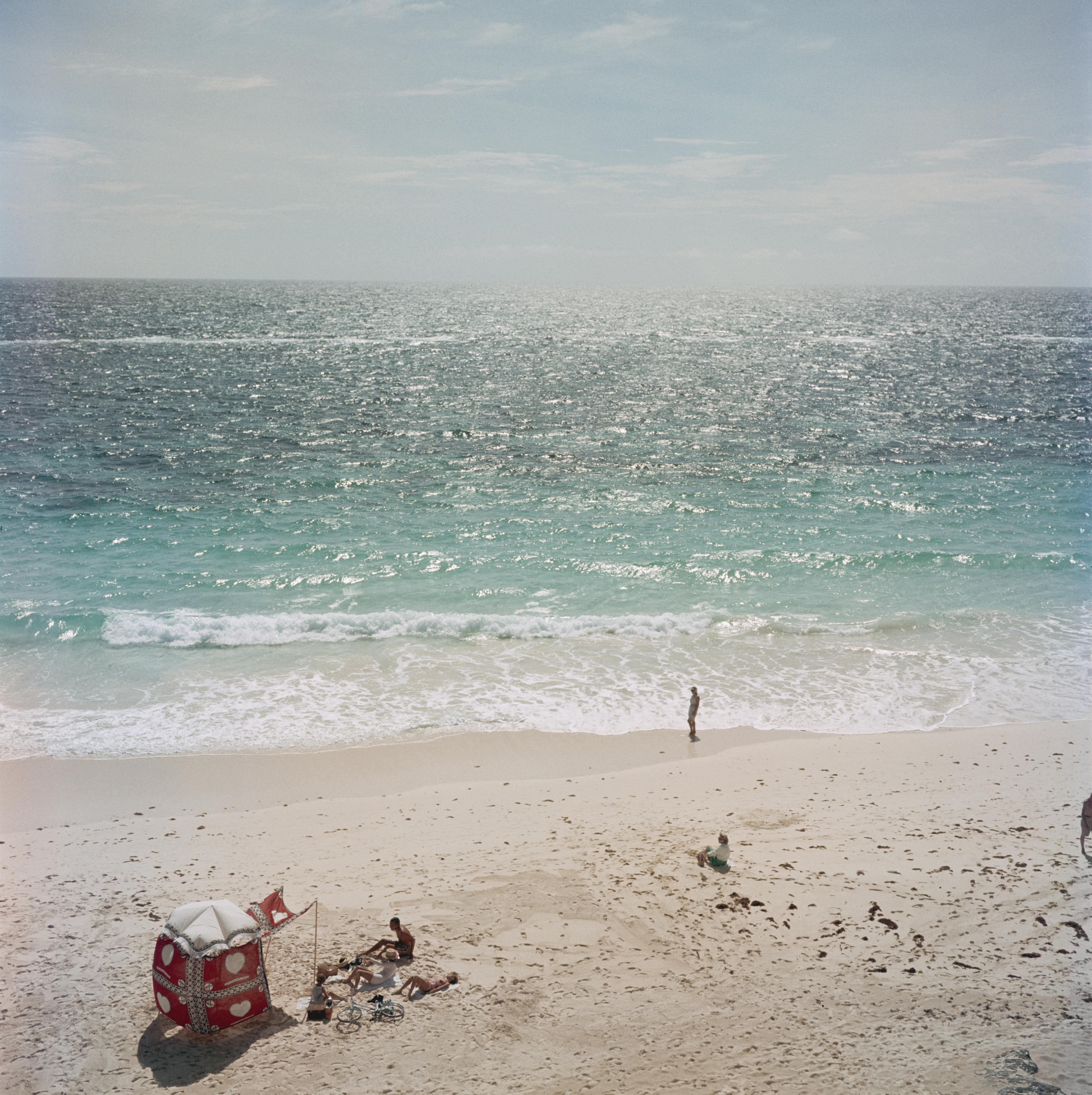 Slim Aarons
Andros Island, 1957
C print
Estate stamped and numbered edition of 150 
with certificate of authenticity

A family enjoying a quiet beach on Andros Island, Bahamas, 1957. 

Slim Aarons (1916-2006) worked mainly for society publications