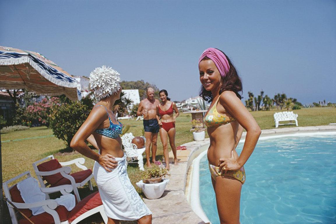 Slim Aarons
Poolside At The Von Pantzs
1967 (printed later)
Chromogenic Lambda Print
Estate stamped and hand numbered edition of 150 with certificate of authenticity. 

Bathers by the pool at El Rincon, the Marbella home of Baron and Baroness von