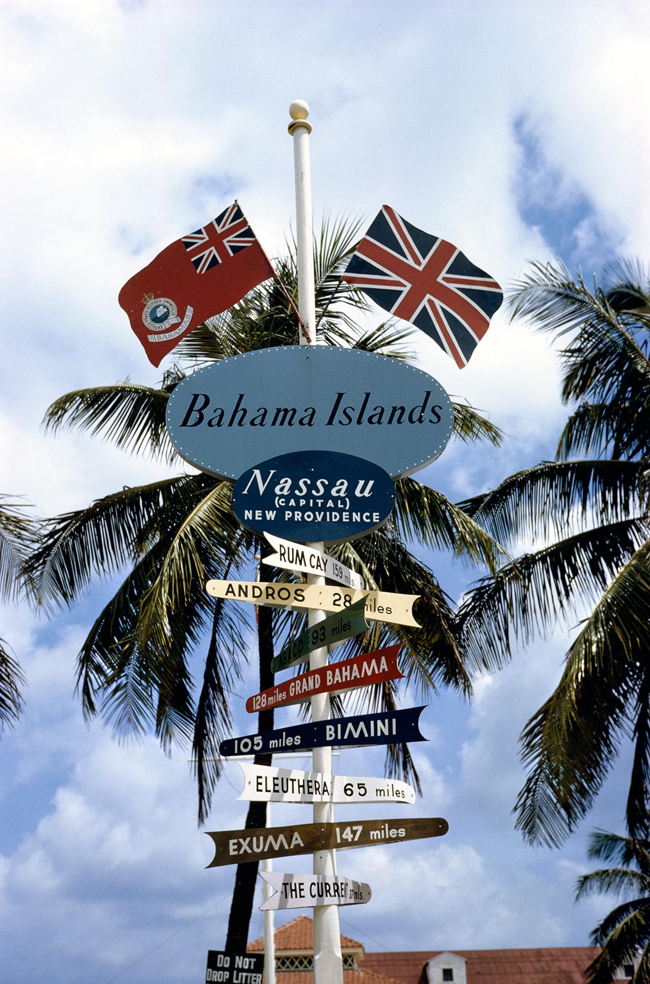 Slim Aarons
Bahamas Signpost
1964
C print
Estate stamped and hand numbered edition of 150 with certificate of authenticity from the estate.   

A signpost in Nassau points the way to Rum Cay, Andros, Abaco, Grand Bahama, Bimini, Eleuthera, Exuma and