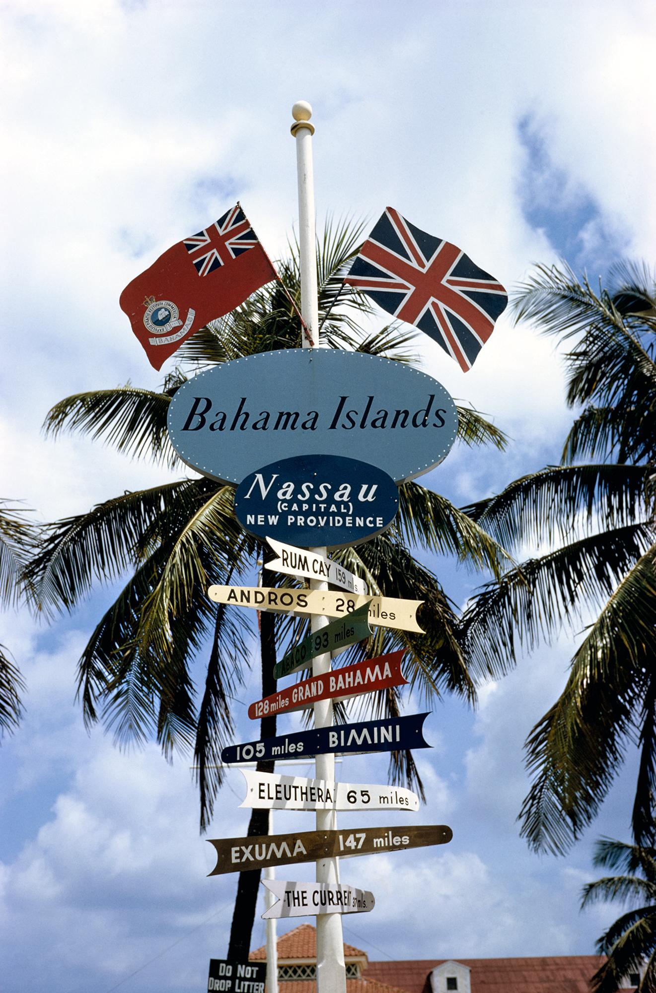Ein Wegweiser in Nassau zeigt den Weg nach Rum Cay, Andros, Abaco, Grand Bahama, Bimini, Eleuthera, Exuma und dem Strom, Mai 1964.  (Foto: Slim Aarons/Hulton Archive/Getty Images)

Schlanke Aarons
Bahamas Wegweiser
1964
C Druck
Nachlassgestempelte
