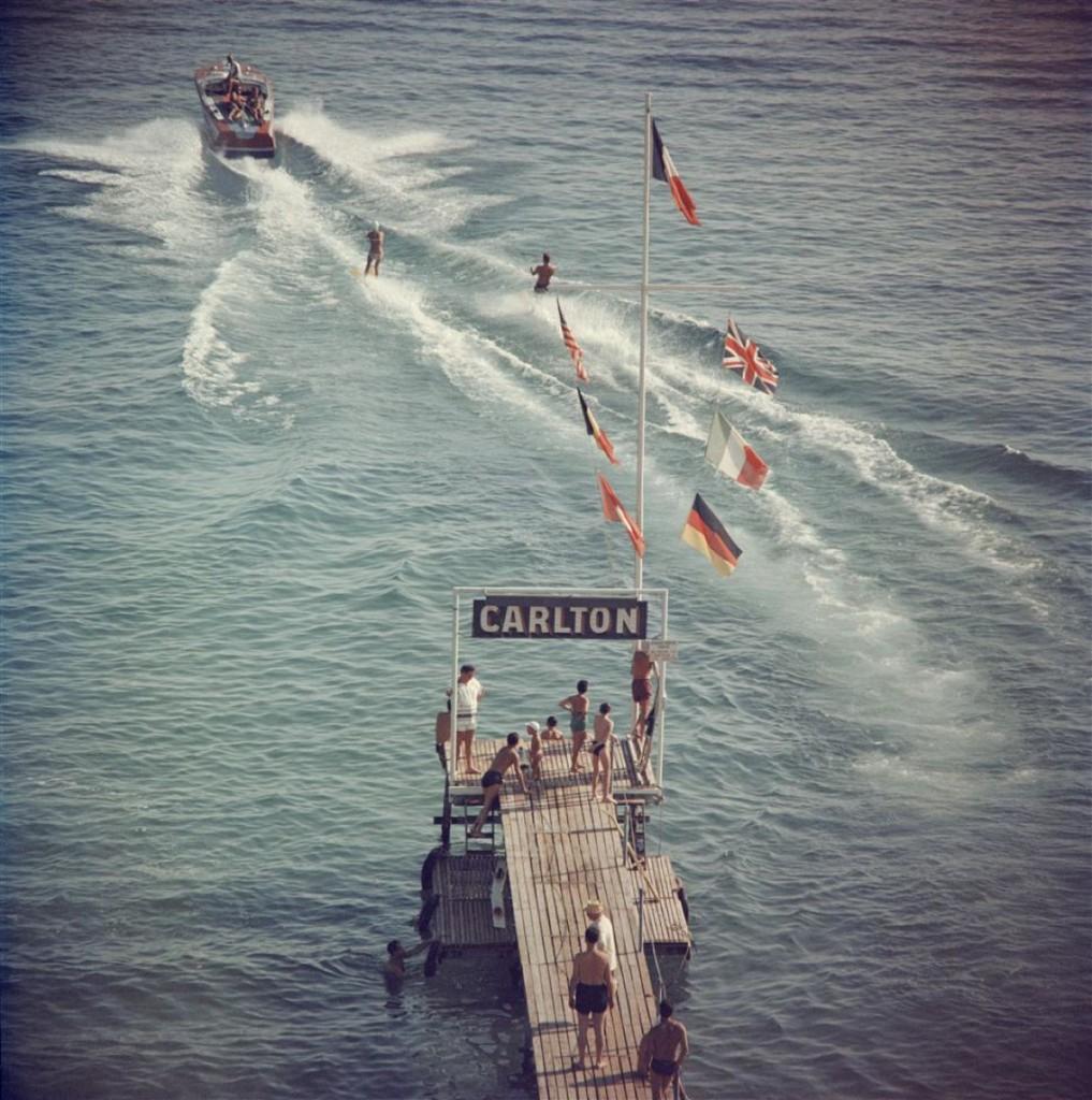 
Slim Aarons - Cannes Watersports - Estate Stamped

 Limited Edition Estate Stamped Print (edition size 1/150). 
Holidaymakers waterskiing from the pier of the Carlton Hotel
Cannes, 1958.

In his words, he loved to photograph 'beautiful people in