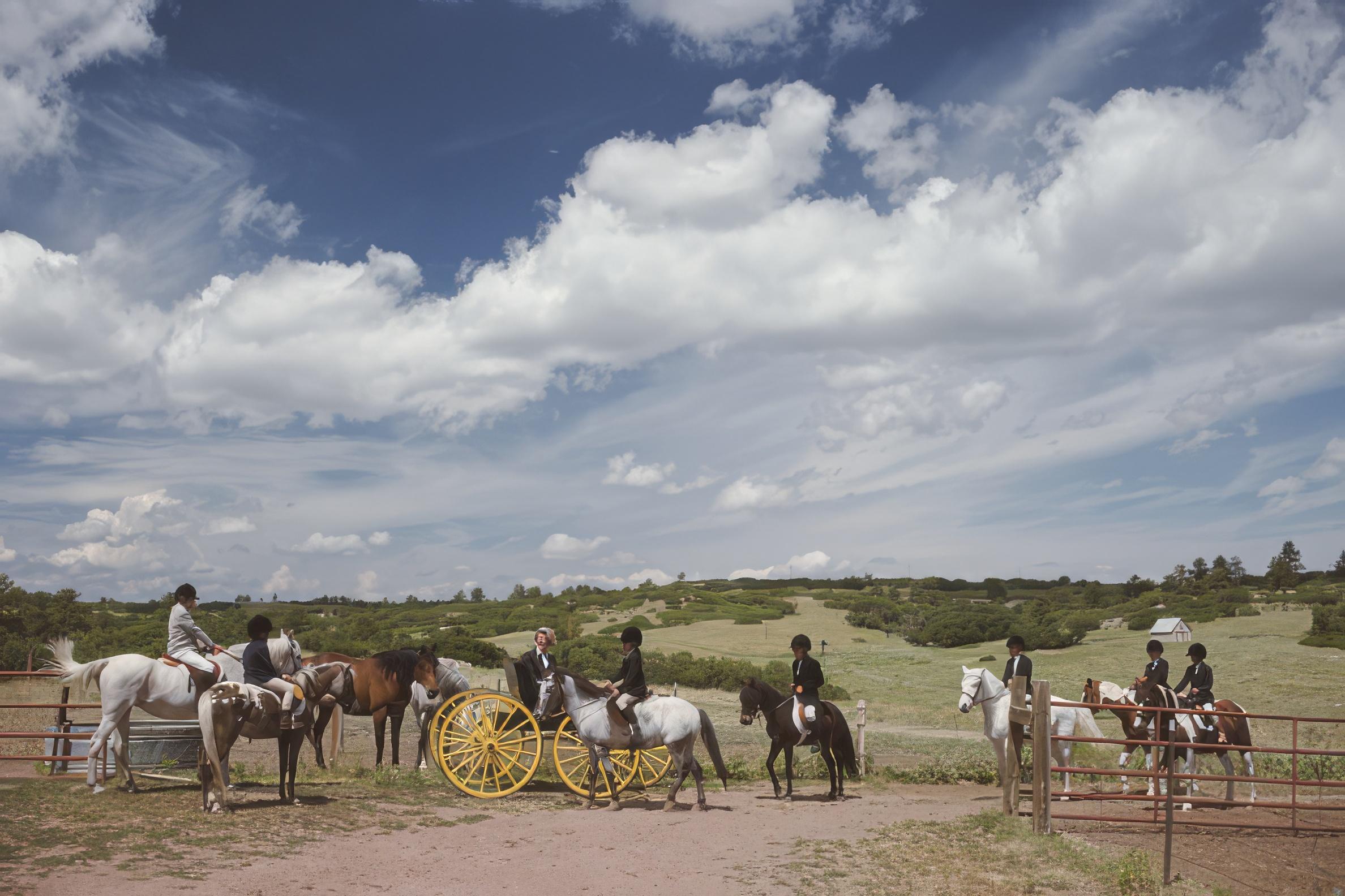 Slim Aarons
Castle Pines, Colorado
1990 (printed later)
C print
Estate stamped and hand numbered edition of 150 with certificate of authenticity from the estate.   

Nancy King (in carriage) with members of the Hunter Hill Pony Club at the Happy