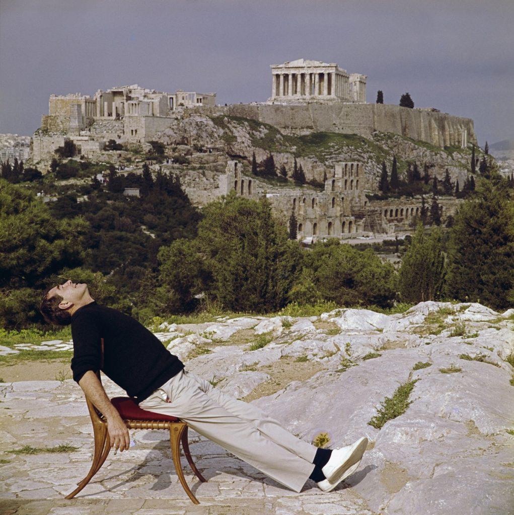 Slim Aarons - Civilised Snooze - Estate Stamped

Photographer Slim Aarons slouches in a chair with the Acropolis and its surroundings as a backdrop. (Photo by Slim Aarons)


This photograph epitomises the travel style and glamour of the period's