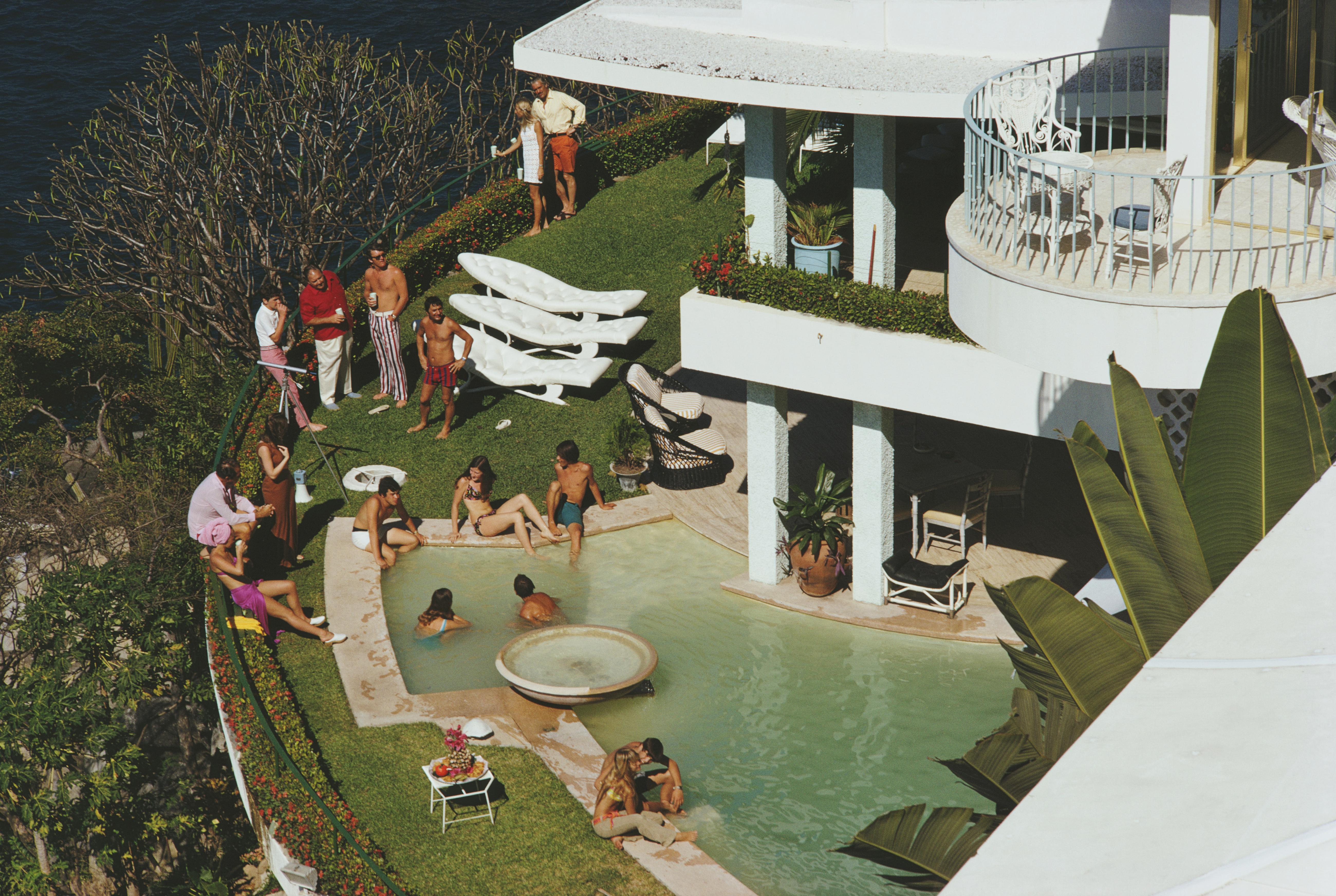 Guests around the clifftop pool at Warren Avis' villa 'La Barranca', Las Brisas, Acapulco, Mexico, January 1971. 

Slim Aarons
'Clifftop Pool'
Chromogenic Lambda print 
Slim Aarons Estate Edition
Complimentary dealer shipping to your framer.

60 x