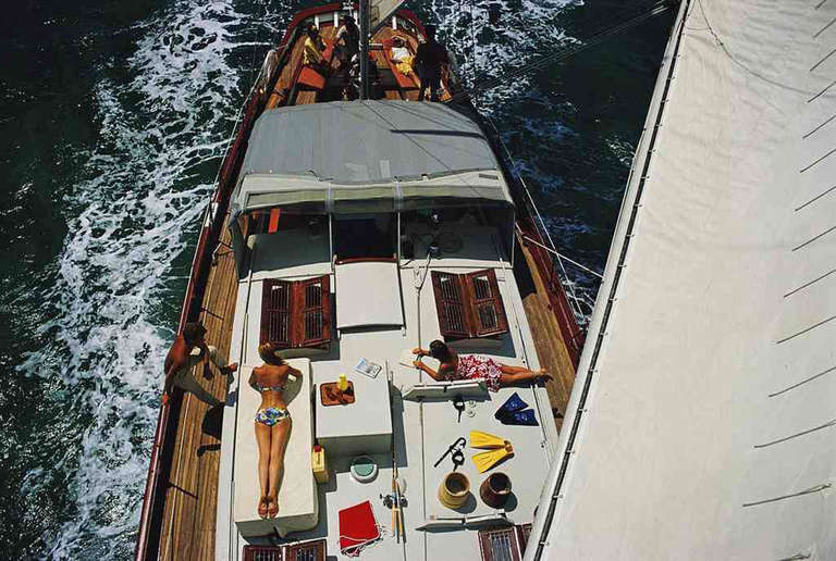 General view looking down on sunbathers on the deck of a yacht, off the coast of the Bahamas, April 1967
Estate stamped and hand numbered edition of 150 with certificate of authenticity from the estate.   

Slim Aarons (1916-2006) worked mainly for