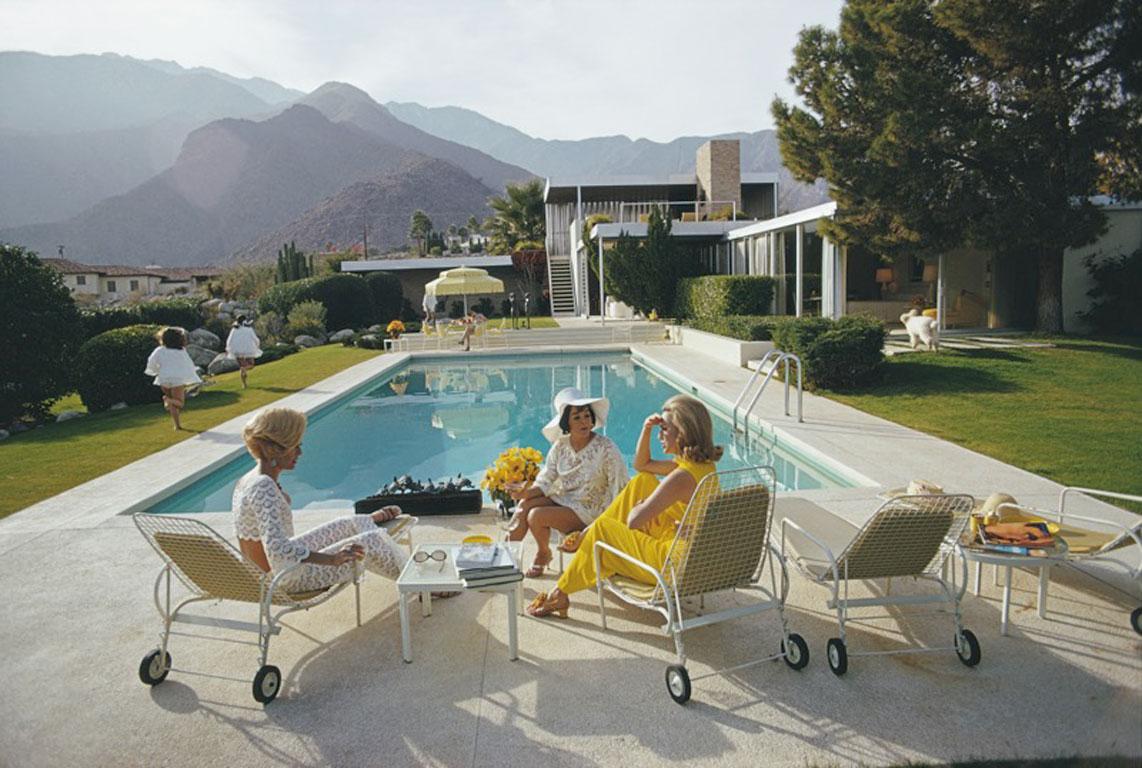 Desert House in Palm Springs, 1970
Chromogenic Lambda Print
Estate edition of 150

Former fashion model Helen Dzo Dzo Kaptur (in white lace), Nelda Linsk (in yellow), wife of art dealer Joseph Linsk, and actress Lita Baron (in white sunhat) at the