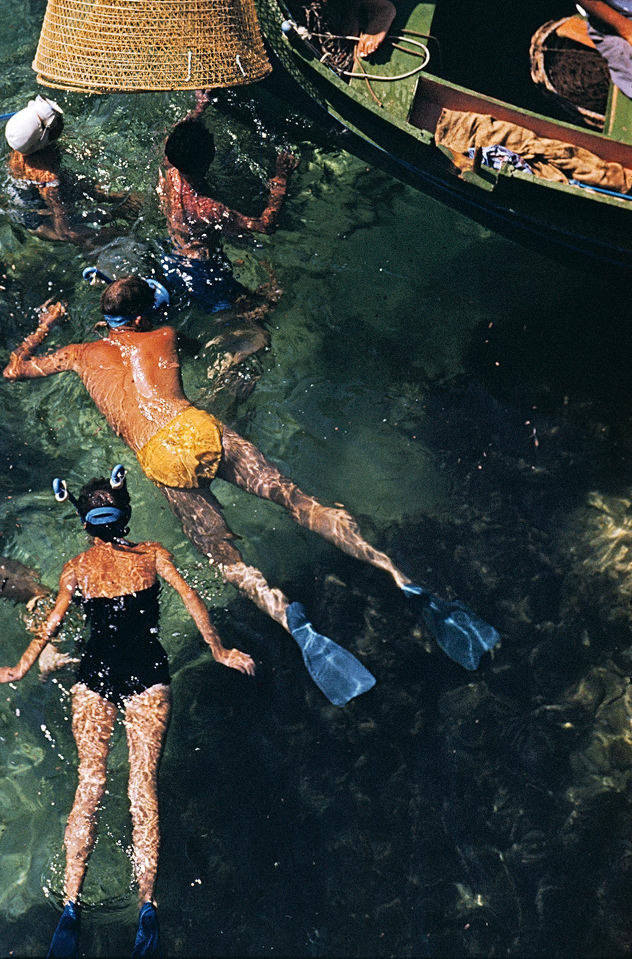 This late 1950s aerial landscape photograph, captured by society photographer Slim Aarons, features group of people snorkelling off a small boat in Malta.

This is an estate stamped and hand numbered edition of 150 with certificate of authenticity