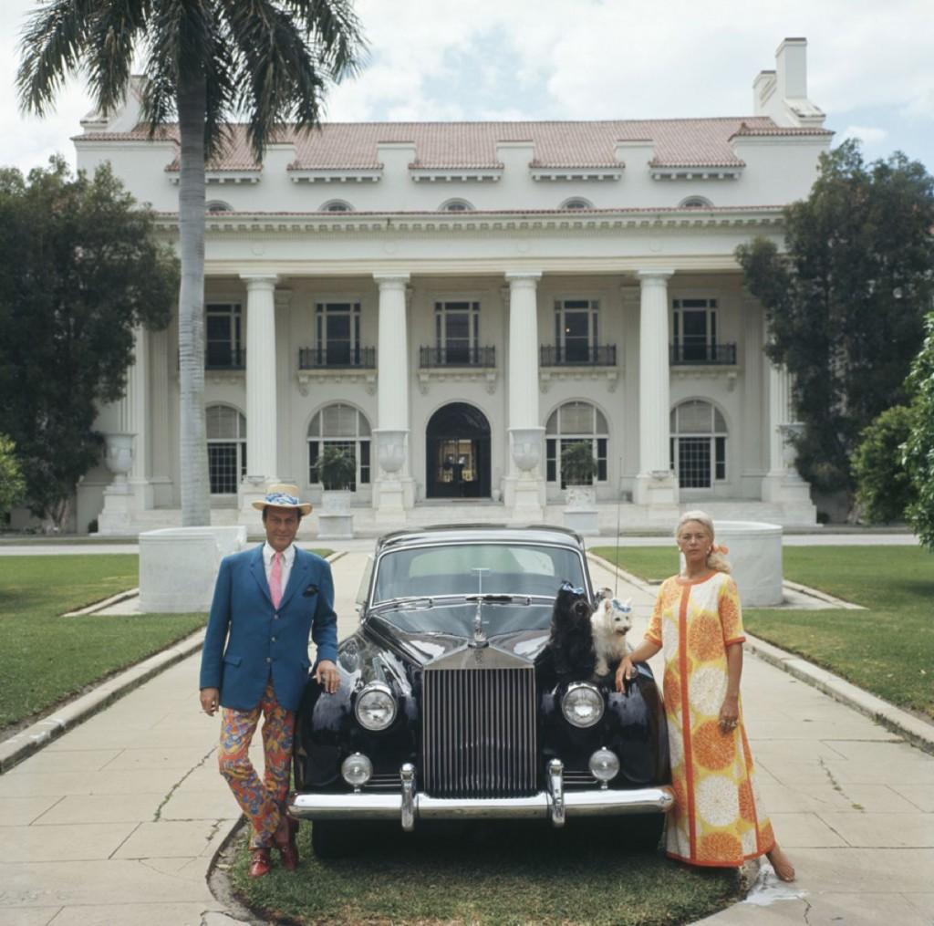 April 1968: Mr and Mrs Donald Leas with their Rolls Royce and two pet dogs outside The Flagler Museum in Palm Beach, Florida.

The colourfully fashionable couple stand next to their black vintage Rolls Royce car, a giant palm tree rises up behind
