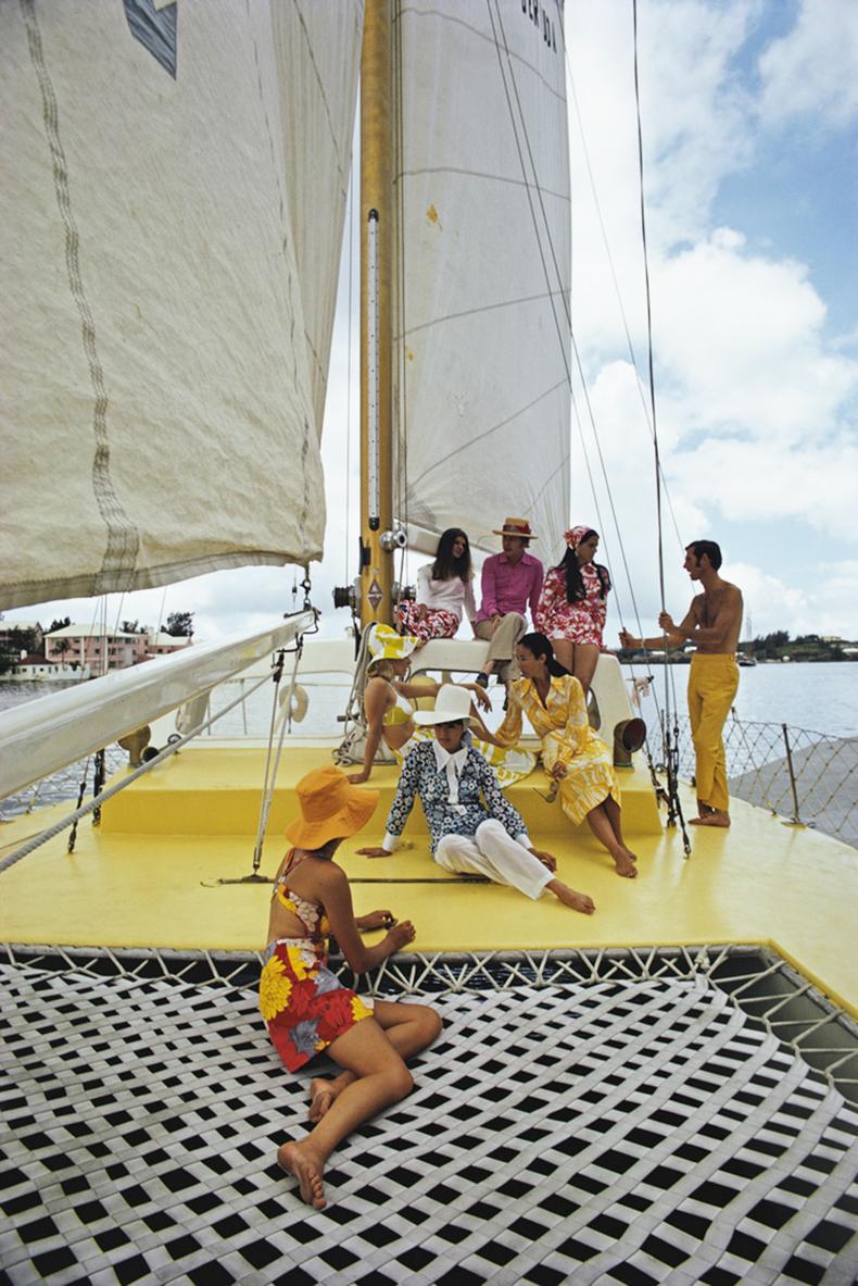 A group of colourfully dressed friends on board the Calypso clothing store owned boat, Bermuda, June 1970. 

(Photo by Slim Aarons)

Estate Stamped Edition 
Limited to 150 only 


This photograph epitomises the travel style and glamour of the