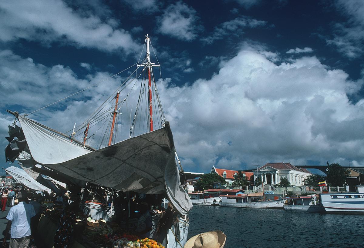 Slim Aarons Estate Stamped Edition 
Limited to 150 only 

A view of a quayside in Curacao, Netherlands Antilles, January 1979. (Photo by Slim Aarons)

This photograph epitomises the travel style and glamour of the period's wealthy and famous,
