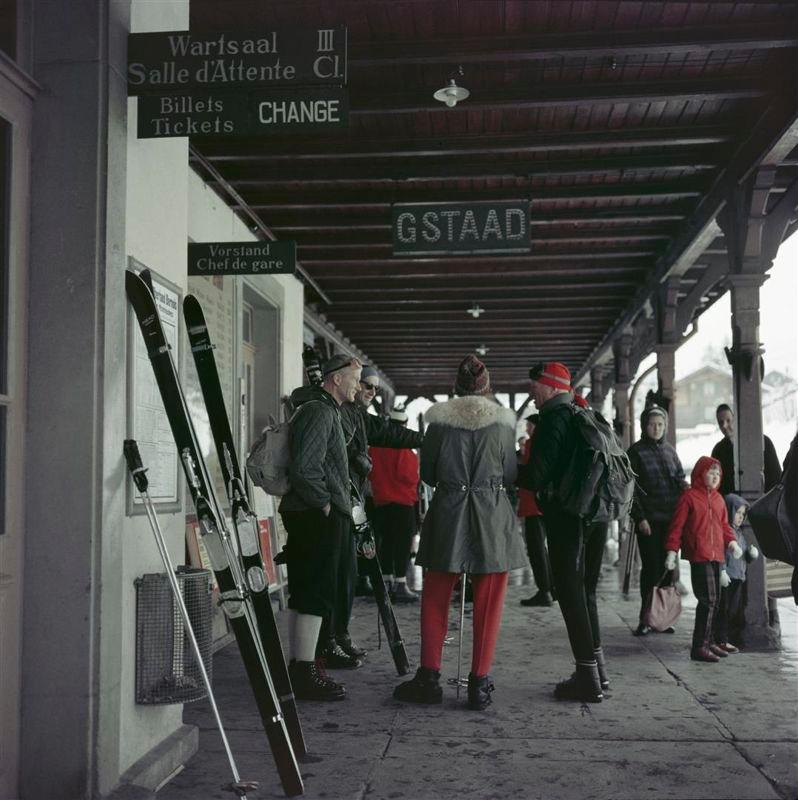 Slim Aarons - Gstaad Station - Estate Stamped Edition 
Limited to 150 only 
Travellers with their skis waiting at Gstaad Station, 1961 (Photo by Slim Aarons). 

This photograph epitomises the travel style and glamour of the period's wealthy and