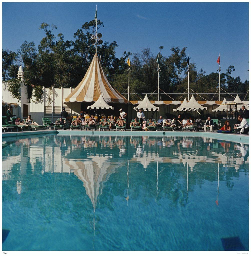 Limited Edition Estate Stamped Print (edition size 1/150).

Holiday makers relaxing by the pool at the Beverly Hills Hotel on Sunset Boulevard in California, 1957. 

This photograph epitomises the travel style and glamour of the period's wealthy and