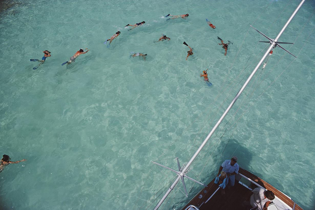 Slim Aarons Estate Stamped Edition 
Limited to 150 only 

Guests on Sidney Gould's 'Sea Quest' boat take a dip in the ocean, Bermuda, September 1977 (Photo by Slim Aarons)

This photograph epitomises the travel style and glamour of the period's