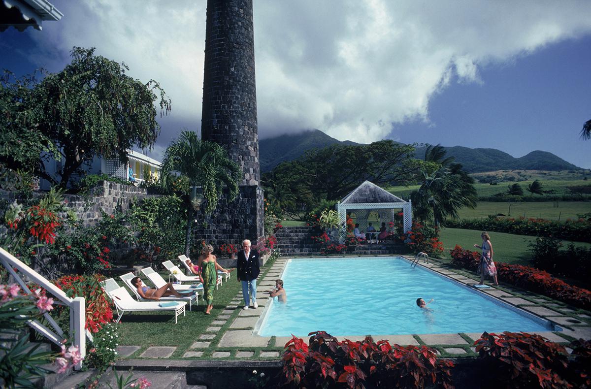 Slim Aarons Estate Stamped Edition 
Limited to 150 only 

Colonel Charles Walwyn and his wife Enid at home on the Rawlins Plantation at the foot of Mount Liamuiga (formerly Mount Misery), in St Kitts, 1984. The property belongs to decendants of the