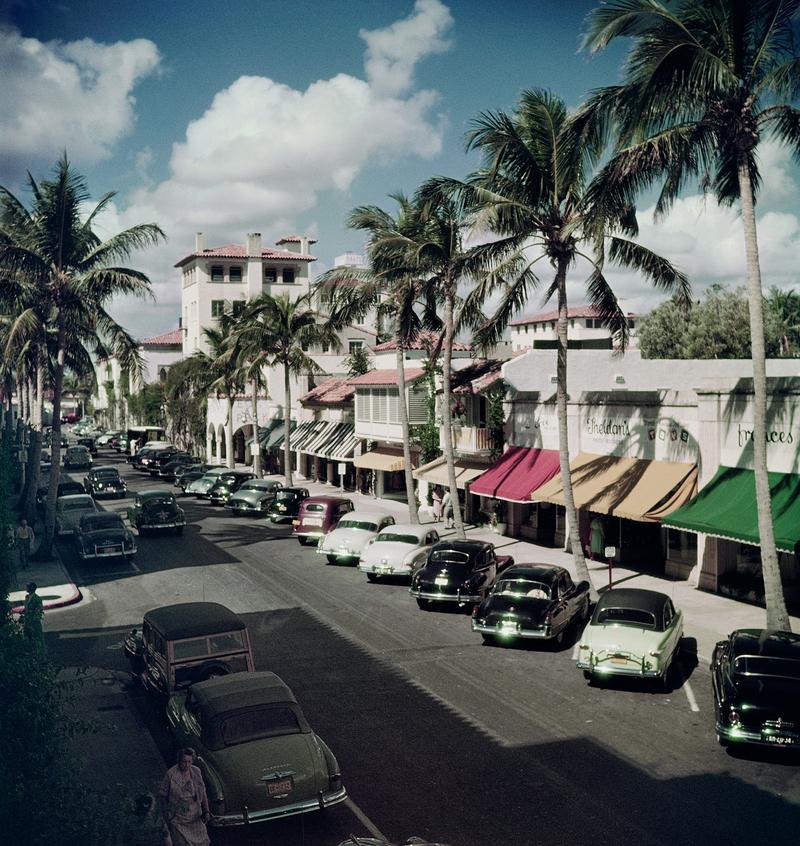Palm Beach Stree

Geparkte Autos in einer von Bäumen gesäumten Straße in Palm Beach, Florida, um 1953.

Foto: Slim Aarons

Chromogener Druck

Papierformat 40 x 40" Zoll / 101 x 101 cm 

Bitte beachten Sie, dass dieses Stück ungerahmt ist - wir