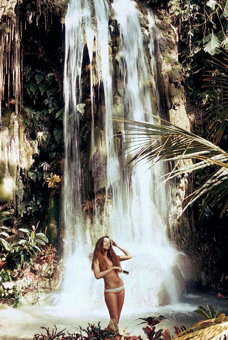 Slim Aarons
Exotic Hair Care
1970 (printed later)
C print 
Estate stamped and numbered edition of 150 
with Certificate of authenticity

A woman combing her hair by a waterfall at Rose Hall, Jamaica, December 1971. (Photo by Slim Aarons/Hulton