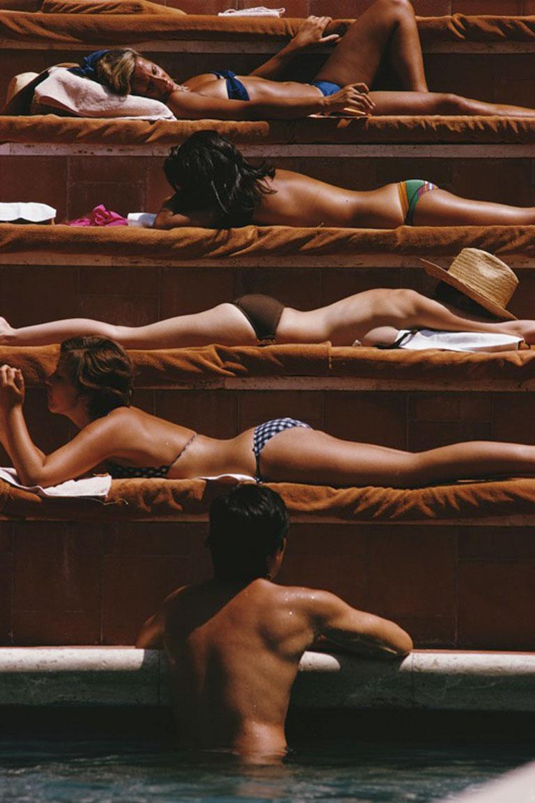 Eye of the Beholder, 1974
Chromogenic Lambda Print
Estate edition of 150

A man contemplates the sunbathers by a swimming pool in Capri, Italy, August 1974.

Estate stamped and hand numbered edition of 150 with certificate of authenticity from the