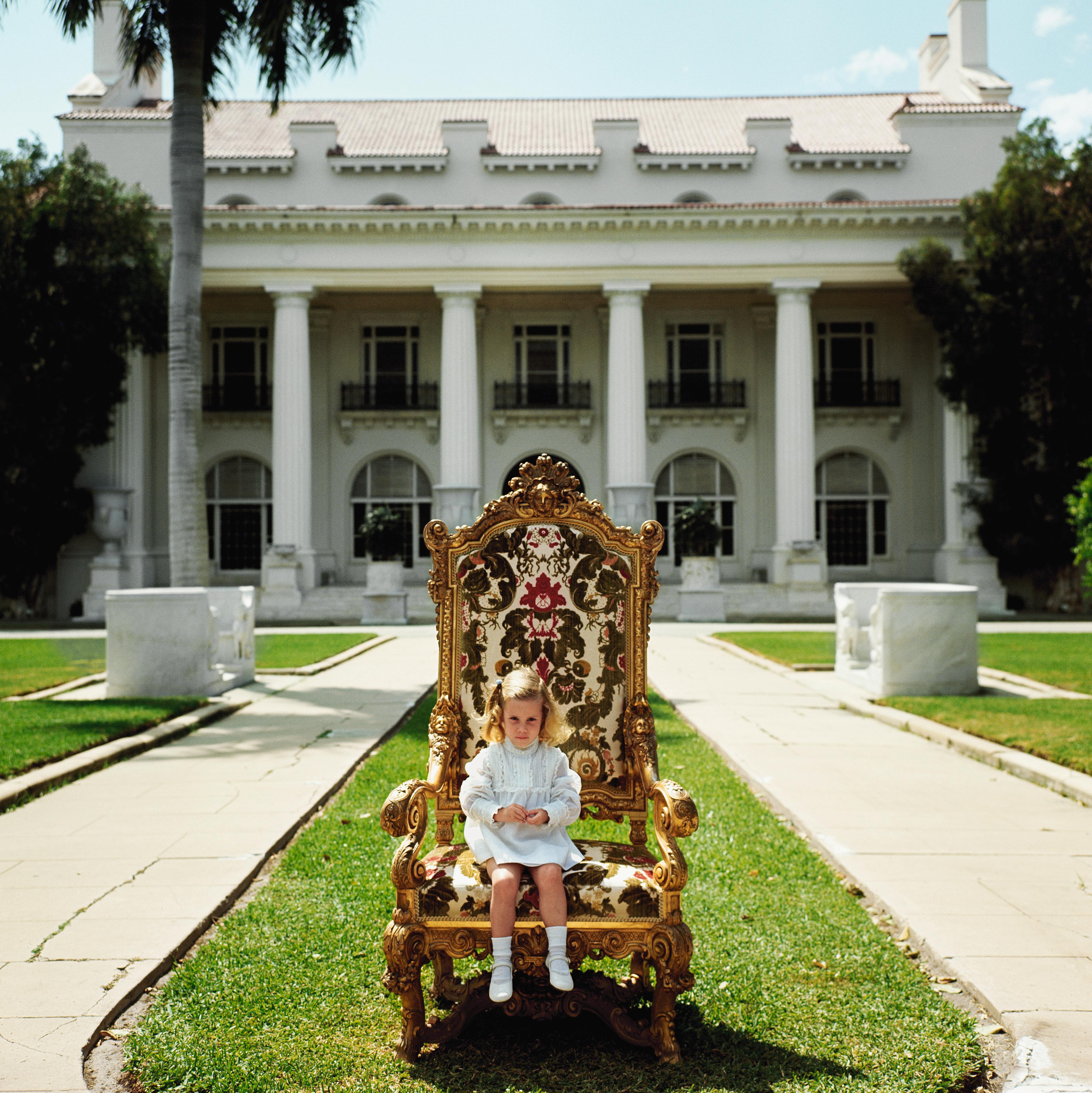 Elizabeth Matthews, descendant of H M Flagler co-founder of Palm Beach, sits in her great-grandfather’s favourite chair in front of the family mansion now the Flagler Museum, Palm Beach, April 1968

Slim Aarons
Family Chair
Chromogenic Lambda