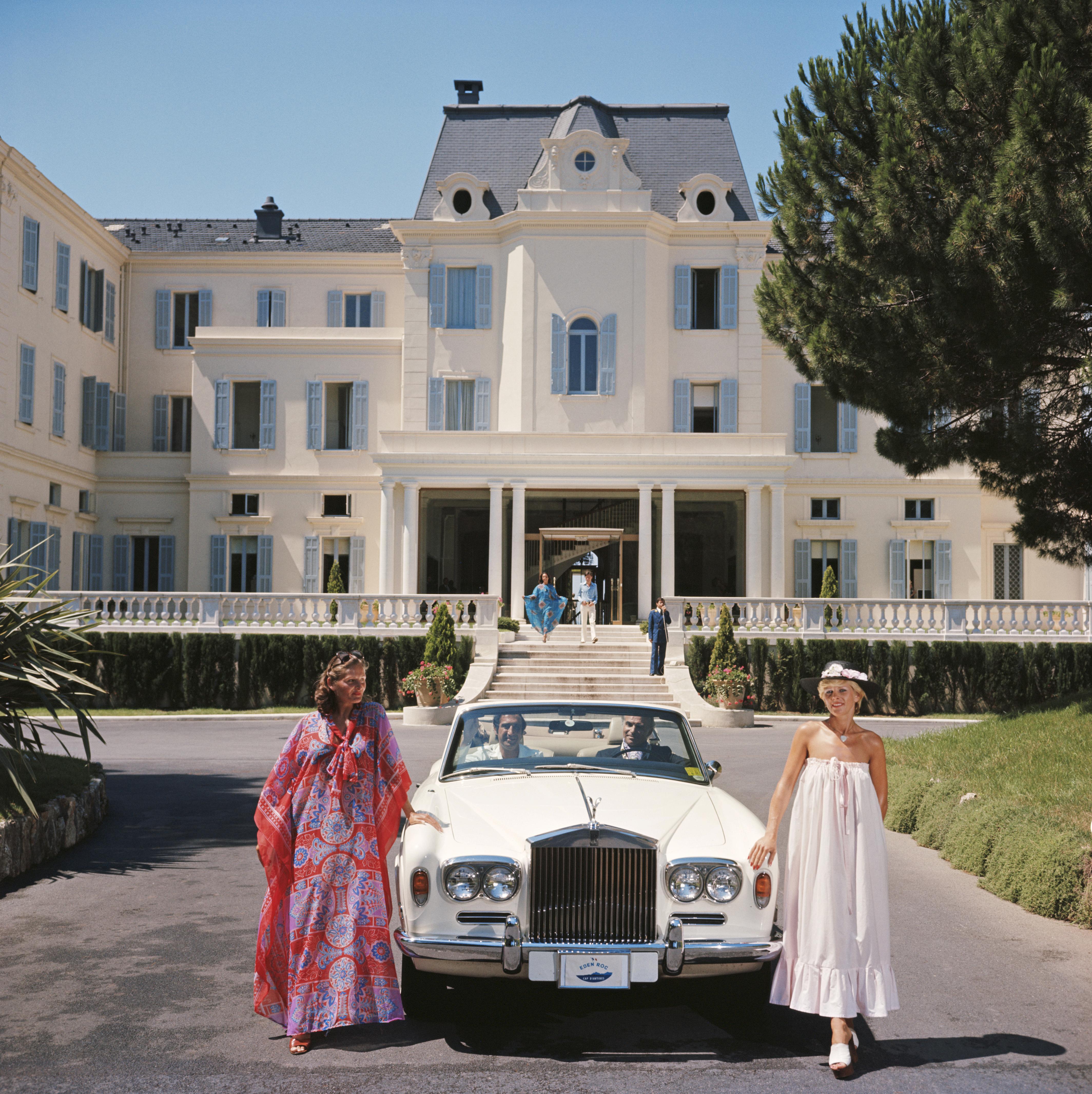 Hotel du Cap-Eden-Roc
1976
C print
30 x 30 inches
Estate stamped and hand numbered edition of 150 with certificate of authenticity from the estate.   

Guests standing by a white Rolls-Royce convertible courtesy car at the Hotel du Cap-Eden-Roc,