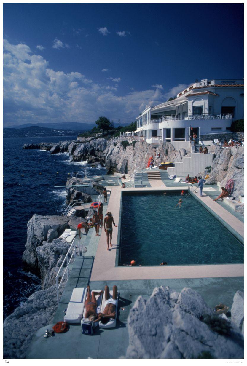 Hotel du Cap Eden-Roc

Guests by the pool at the Hotel du Cap Eden-Roc, Antibes, France, August 1976.

(Photo by Slim Aarons)

Unframed (Premium Collection) Limited Edition Estate Stamped Print
(Full framing service available – please