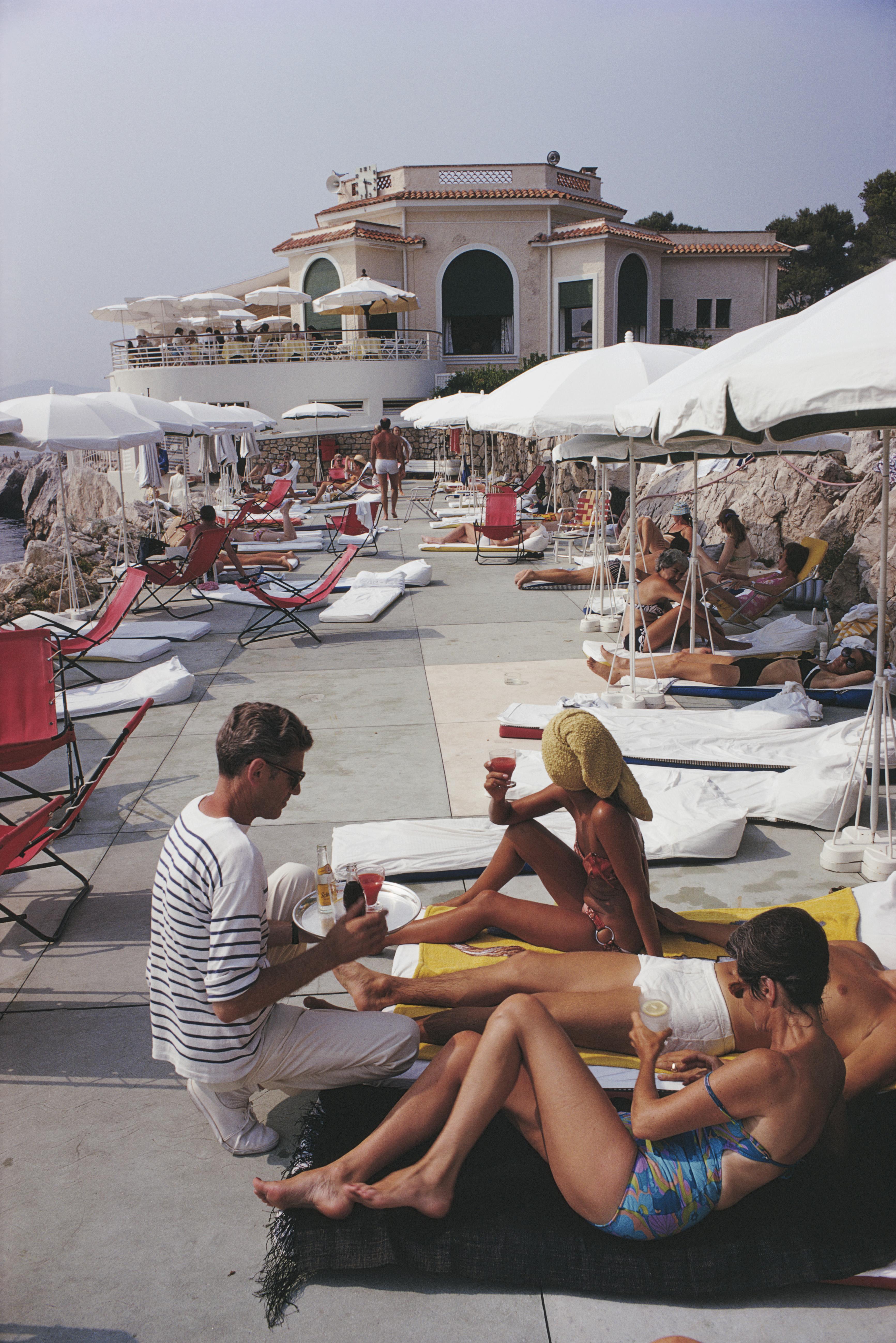'Hotel Du Cap' 1969 Slim Aarons Limited Estate Edition Print 
Holidaymakers at the Hotel du Cap Eden-Roc, Antibes on the French Riviera, 1969. 

Slim Aarons Chromogenic C print 
Printed Later 
Slim Aarons Estate Edition 
Produced utilising the only