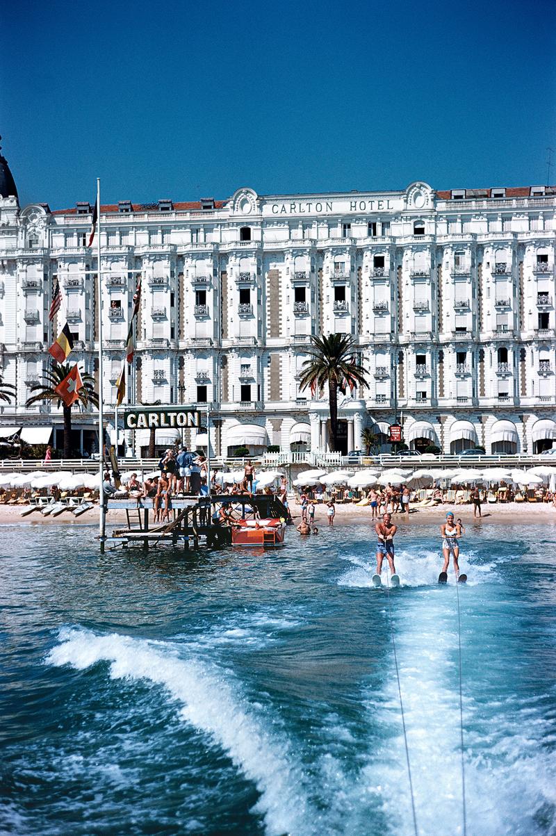 Hotel Sports 
Limited Edition Estate Stamped Print (edition size 150 only). 
1958: Holidaymakers water-skiing in front of the Carlton Hotel, Cannes.
France
 (Photo by Slim Aarons)

20x24" inches / 51 x 61 cm paper size 
numbered in ink to 150 in