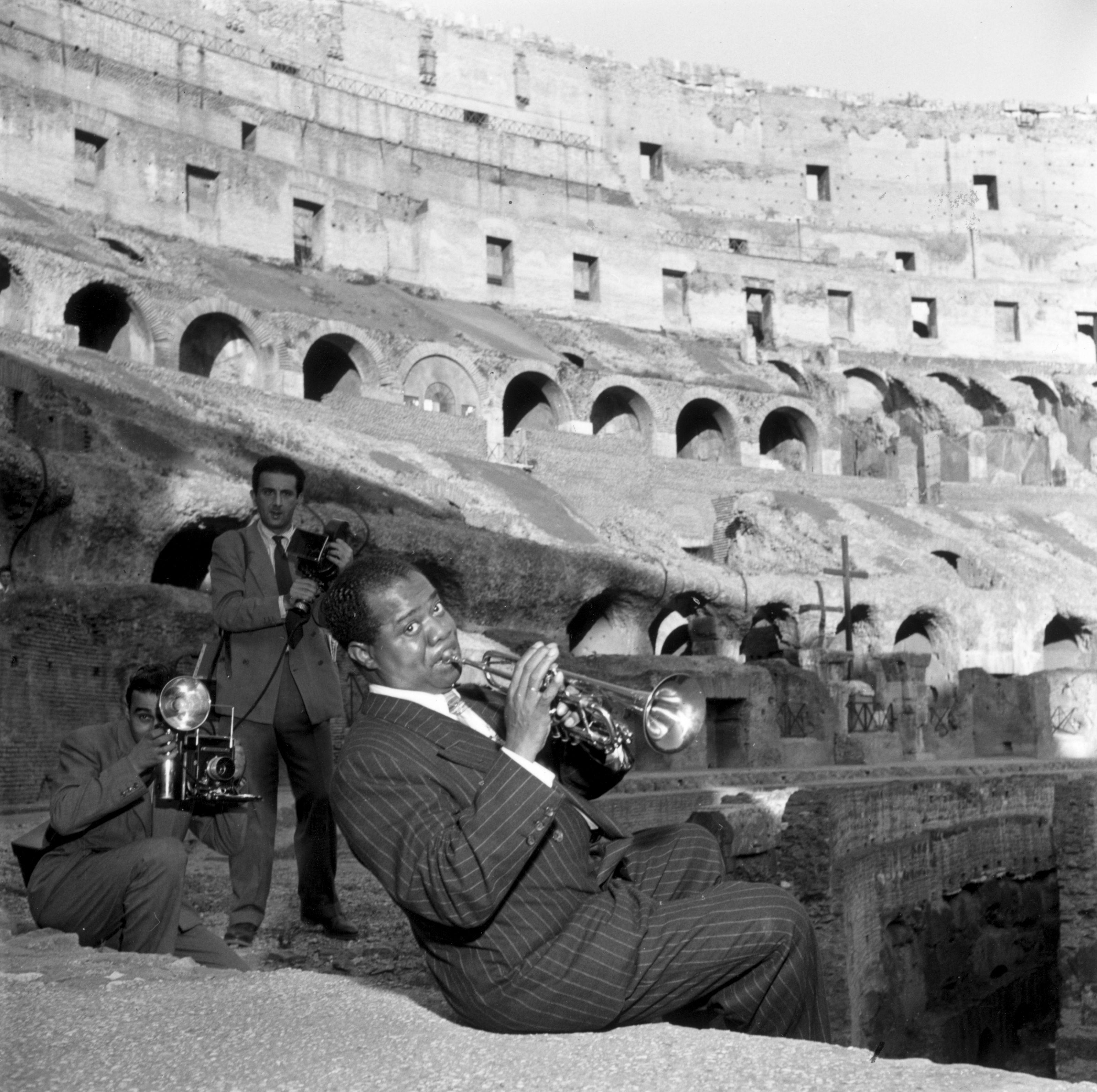 Slim Aarons
King of Jazz
1949 (printed later)
Silver gelatin print
estate signature stamped edition of 150 
with certificate of authenticity

1949: Photographers taking pictures of American jazz trumpeter and singer, Louis Armstrong (1901 - 1971) as