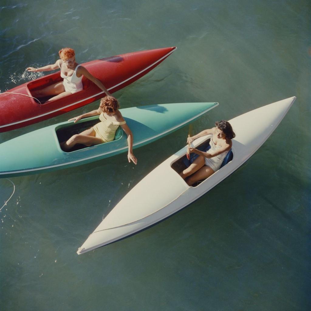 Slim Aarons - Lake Tahoe  Canoes - Estate Stamped 

 Limited Edition Estate Stamped Print (edition size 1/150). 
Young women canoeing on the Nevada side of Lake Tahoe, 1959.

This photograph epitomises the travel style and glamour of the period's