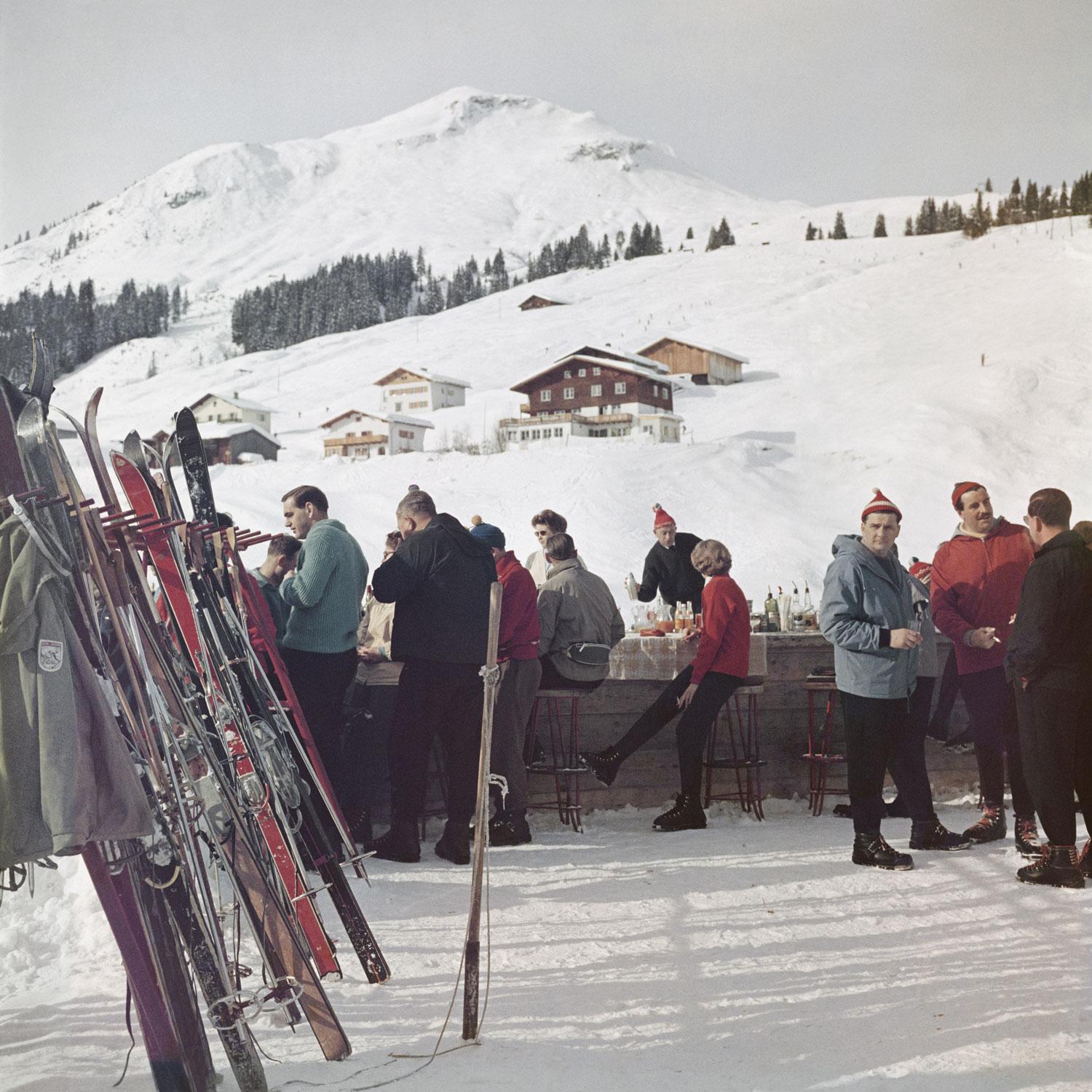 Lech Ice Bar
1960
C-Print
Estate signature stamped and hand numbered edition of 150 with certificate of authenticity from the estate.   

Skiers enjoy a drink by the Ice Bar at the Hotel Krone in Lech, Austria, 1960. (Photo by Slim Aarons/Hulton