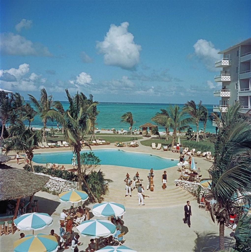 Nassau Beach Hotel 1959 Slim Aarons Estate Stamped 

The outdoor swimming pool at Nassau Beach Hotel, Nassau, Bahamas, 1959. The hotel was the first to built by Howard Johnson outside the United States.

Produced from the original