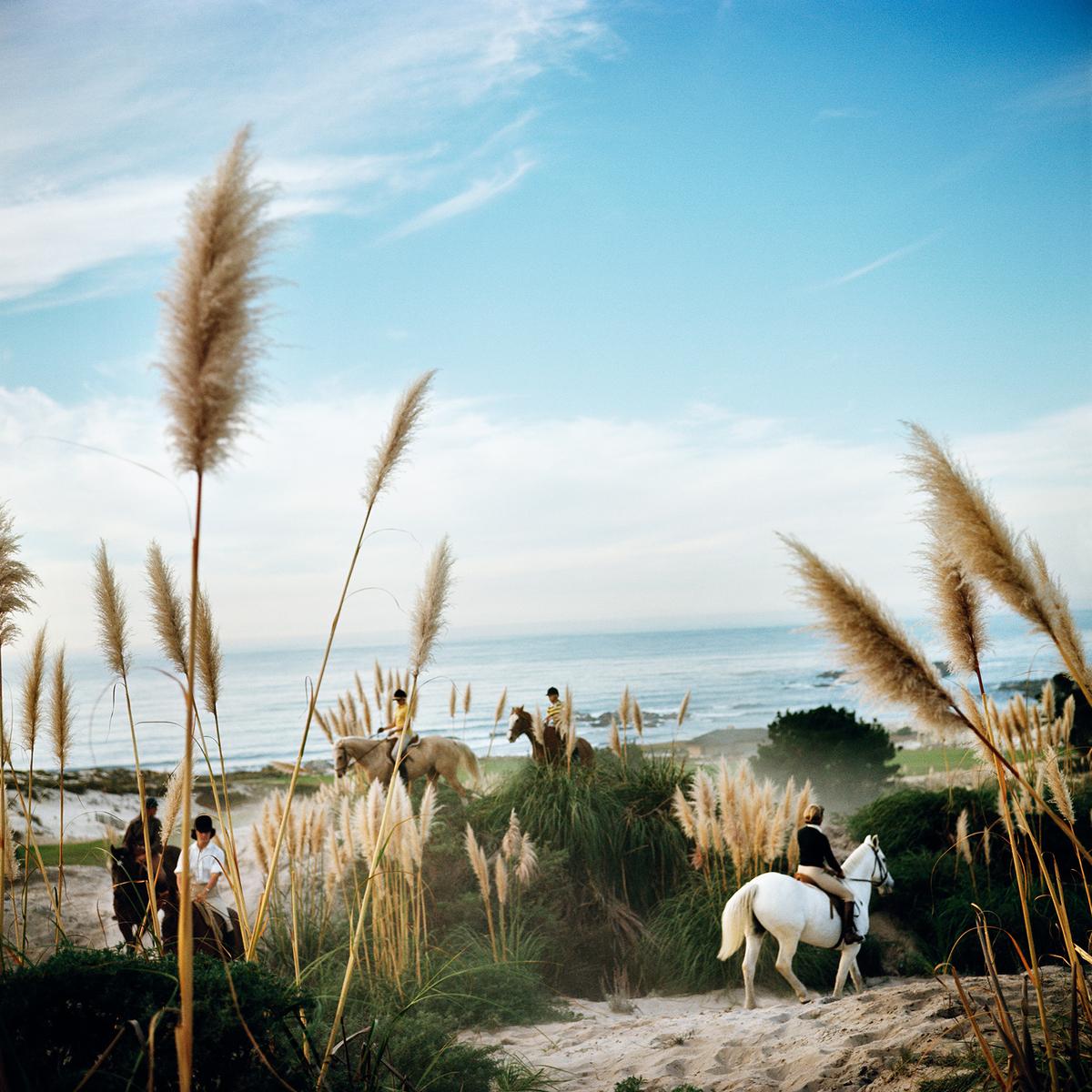 Pebble Beach

Riders from the Pebble Beach Equestrian Centre wind their way through the Californian sand dunes and pampas grass, November 1976.

Chromogenic C print 
Printed this year 
Slim Aarons Estate Edition 

Produced utilising the only