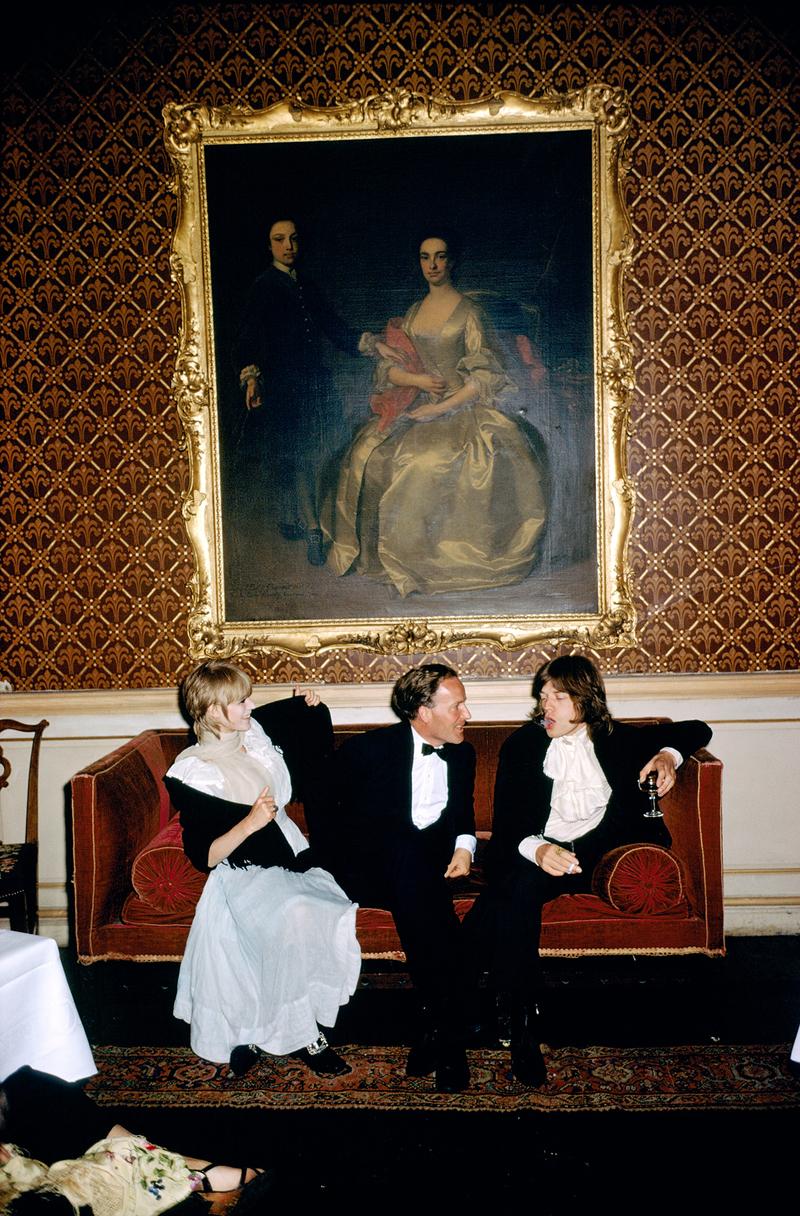Slim Aarons Estate Print - Pop And Society - Oversize

From left to right; singer Marianne Faithfull, the Honorable Desmond Guinness and Mick Jagger (of the Rolling Stones) sit on a sofa under a large gilt framed painting of a woman in 18th century