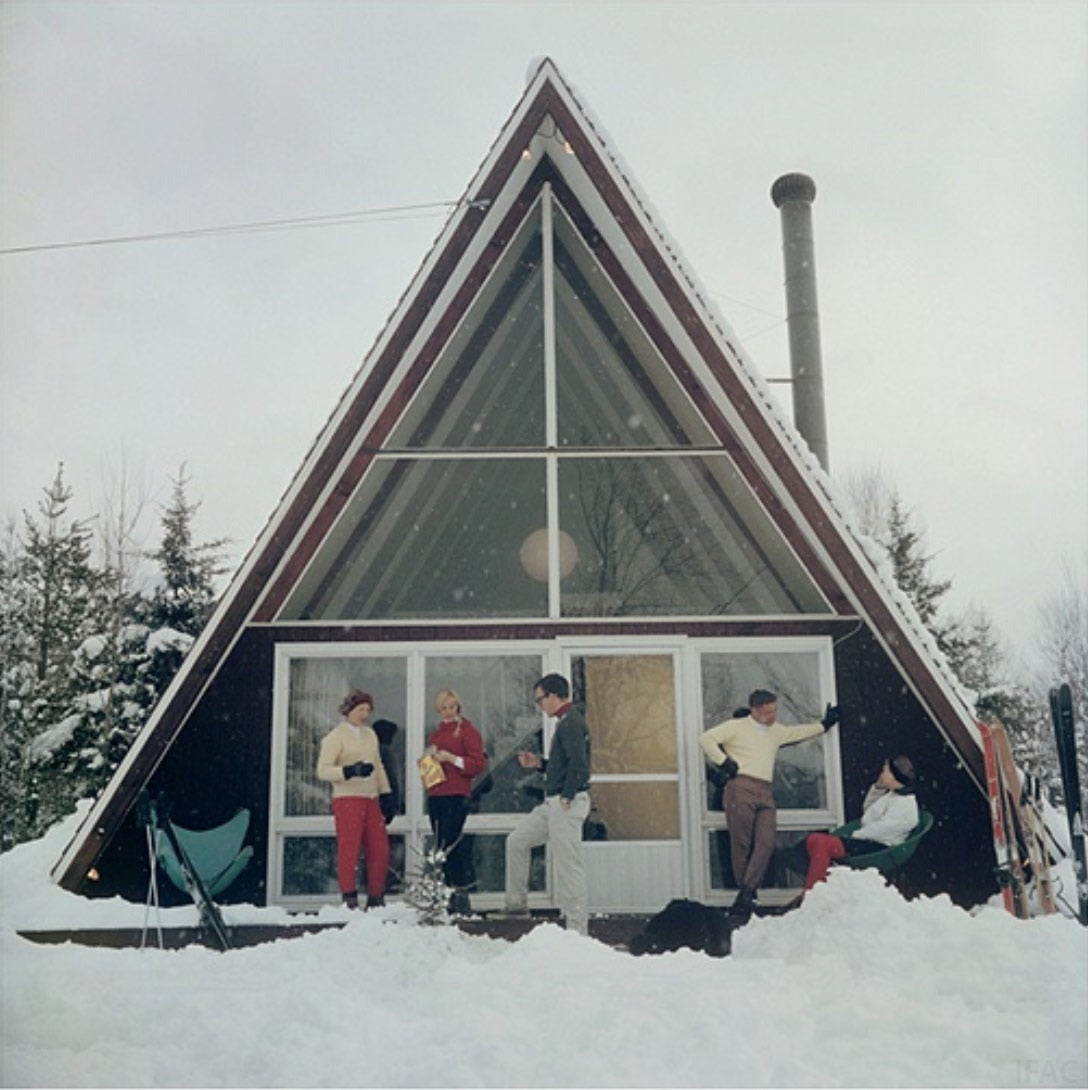 Five people relaxing on the terrace of the glass-fronted triangular Skaal House in the Stowe Mountain ski resort in Stowe, Vermont, 1962. The property is owned by Doris Molliel, who stands to the left of the group.

Estate stamped and hand numbered