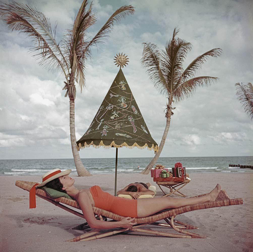 Palm Beach Idyll, 1955 
C-print
30 x 30 inches

A couple sunbathe by the sea at Palm Beach Florida 1955 USA 

Slim Aarons (1916-2006) worked mainly for society publications photographing "attractive people doing attractive things in attractive