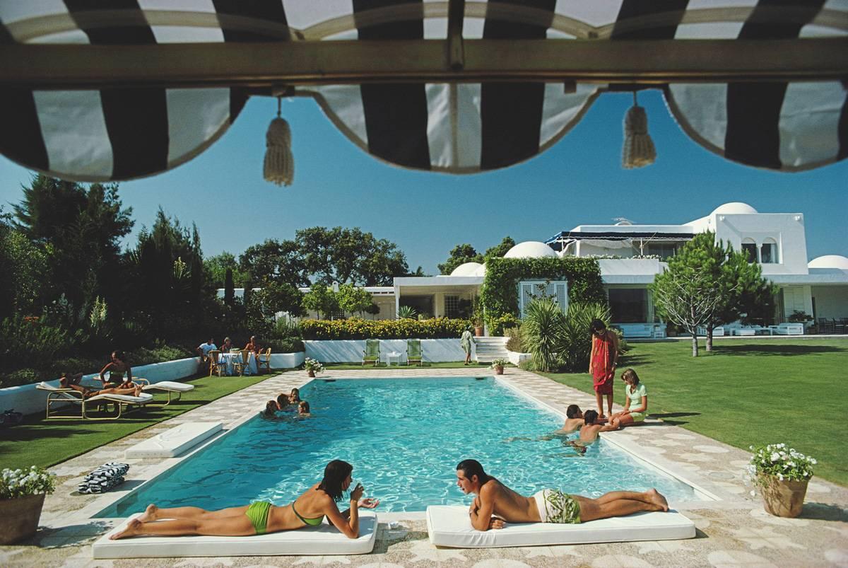 Slim Aarons Color Photograph - Poolside at Sotogrande, Estate Edition: Vintage 70s glamour in Andalusia, Spain