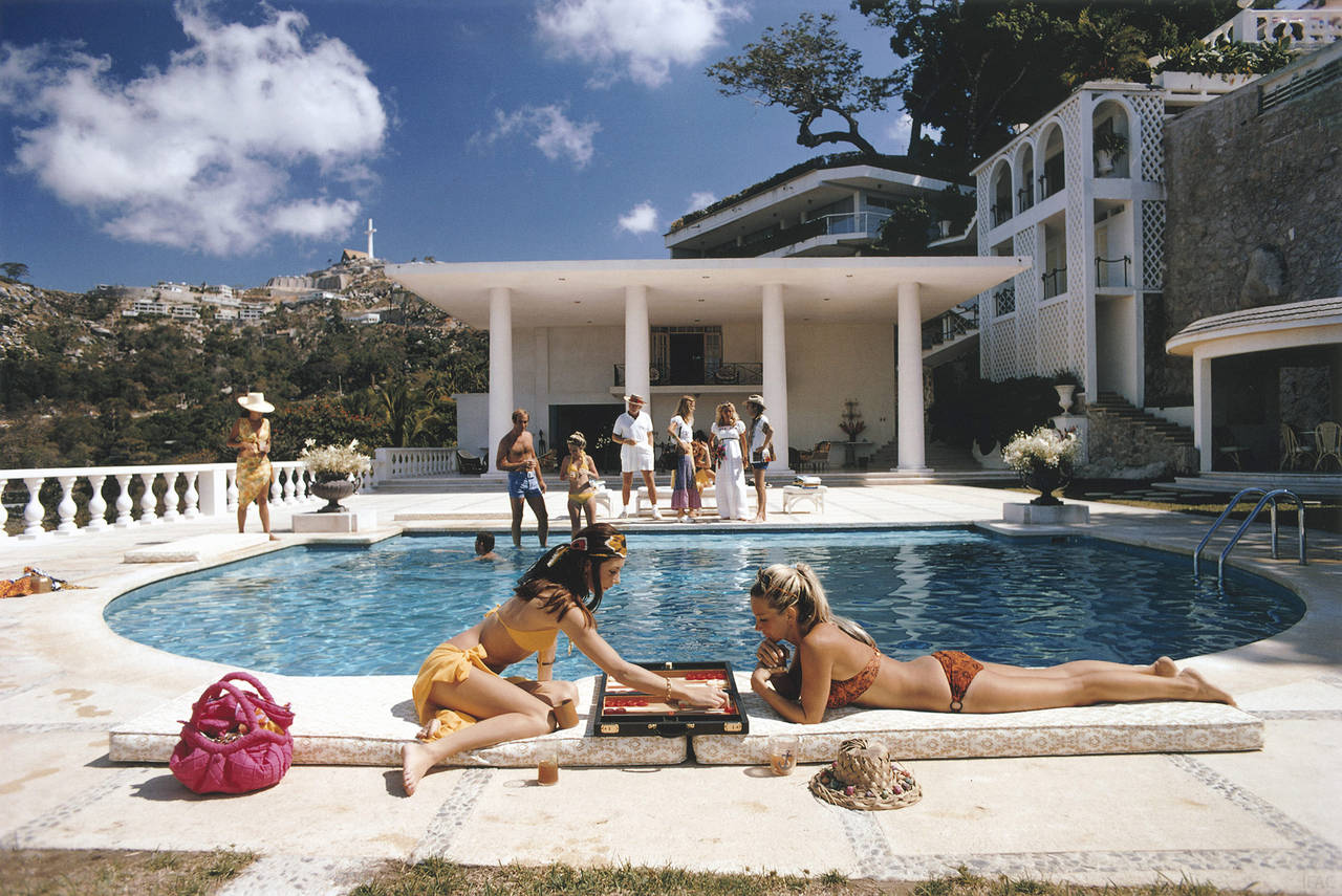 Poolside Backgammon
1972
C print
Estate stamped and hand numbered edition of 150 with certificate of authenticity from the estate. 

Guests at the Villa Nirvana, owned by Oscar Obregon, in Las Brisas, Acapulco, Mexico, 1972. 

Slim Aarons