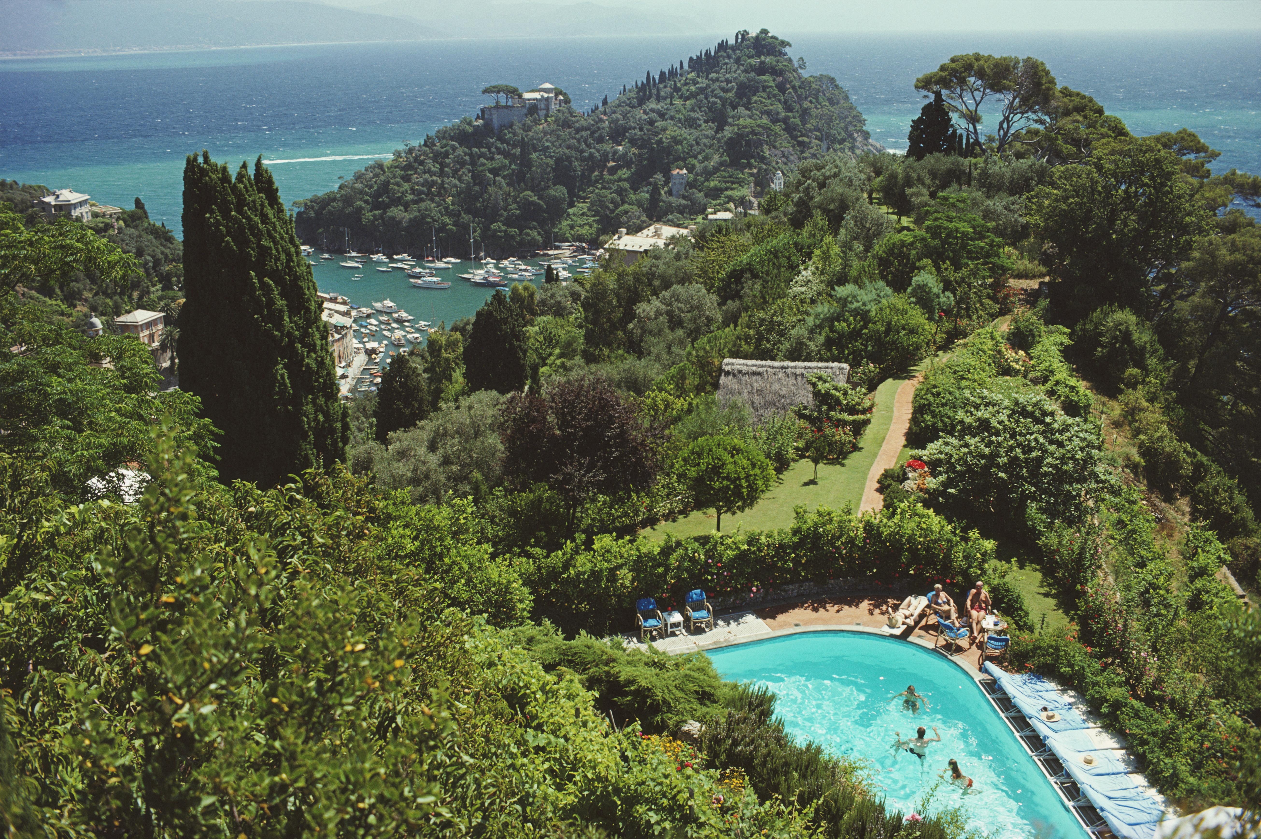 Slim Aarons
Portofino Villa, 1977. (printed later)
C print 
Estate stamped and numbered edition of 150 
with Certificate of authenticity

Guests by the pool at Klaus Pudel's villa, the Casa Montefino, overlooking Portofino harbour, Portofino, Italy,