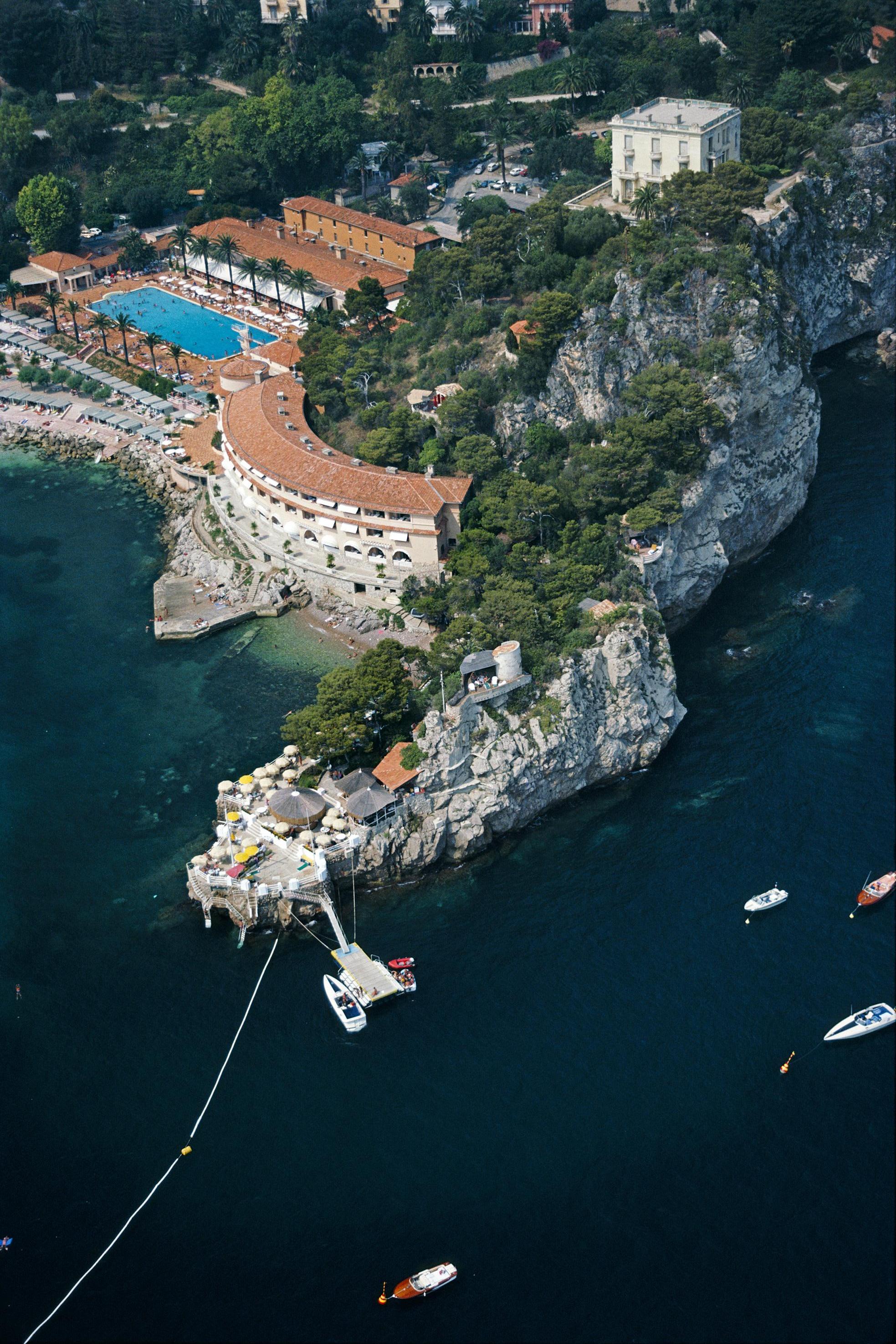The Monte-Carlo Beach Hotel on the Pointe de la Vieille in Roquebrune-Cap-Martin, southeastern France, August 1981. 

Slim Aarons
Roquebrune-Cap-Martin
1981
C print (Printed later)
Estate signature stamped and hand numbered edition of 150 with
