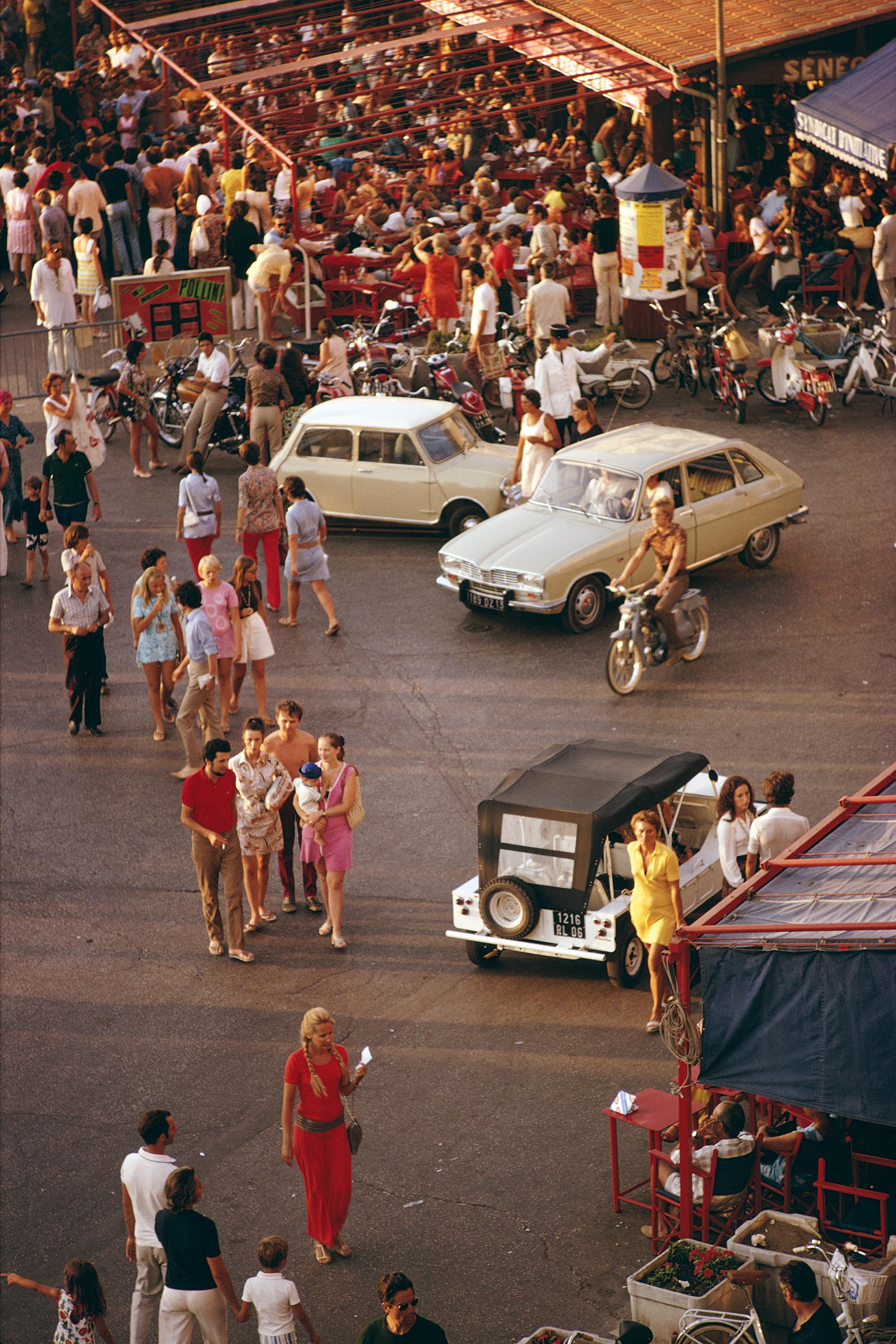 Saint-Tropez Sunbathers, 1971 
Estate stamped and hand numbered edition of 150 with certificate of authenticity from the estate.

Cars and pedestrians on the busy seafront at Saint-Tropez, in southeastern France, September 1970. (Photo by Slim