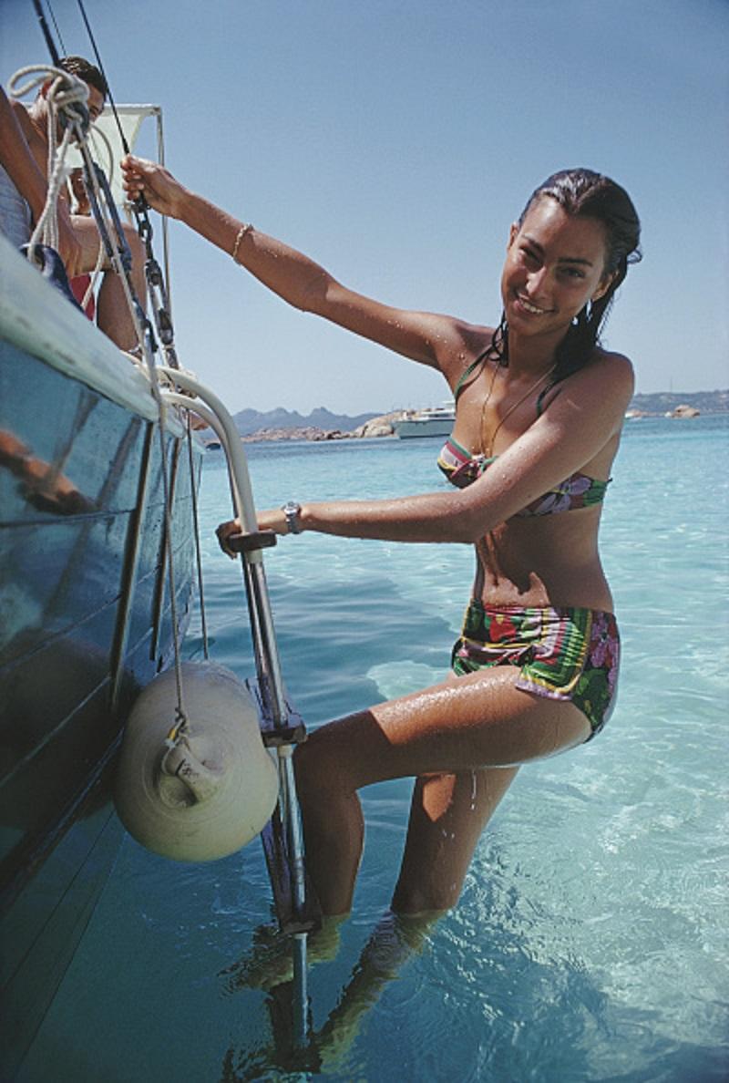 'Sardinian Holiday' 1967 Slim Aarons Limited Estate Edition Print 
Selvaggia Borromeo enjoys a yachting holiday on the Costa Smeralda in Sardinia, 1967. 

Paper size 40 x 30 inches / 101 x 76 cm 
Printed in 2024 - produced from the original