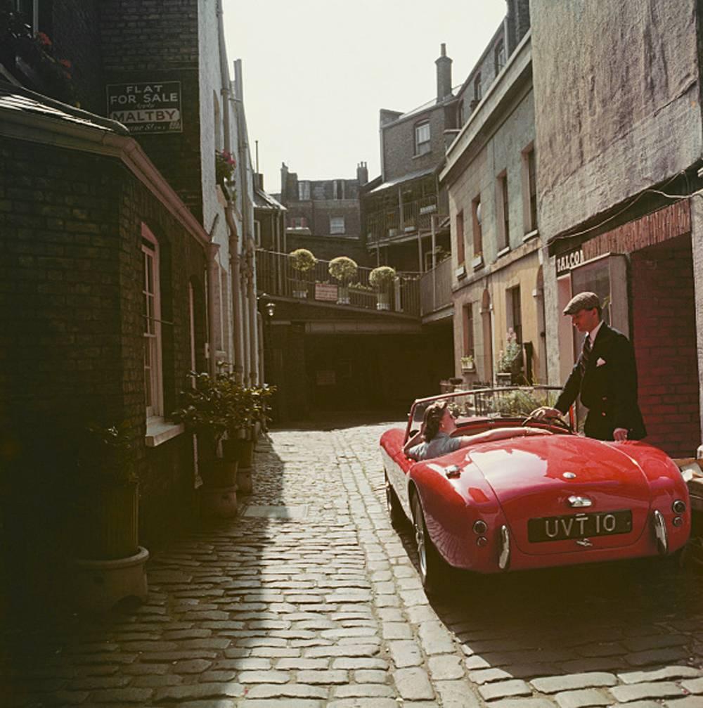 1955: John Bryant with his AC sports car in Kinnerton Place, London SW1, Printed Later. His passenger is Margaret McAulay. 

40 x 40 inches
$3950

30 x 30 inches
$3350

20 x 20 inches
$3000

Complimentary dealer shipping to your framer,