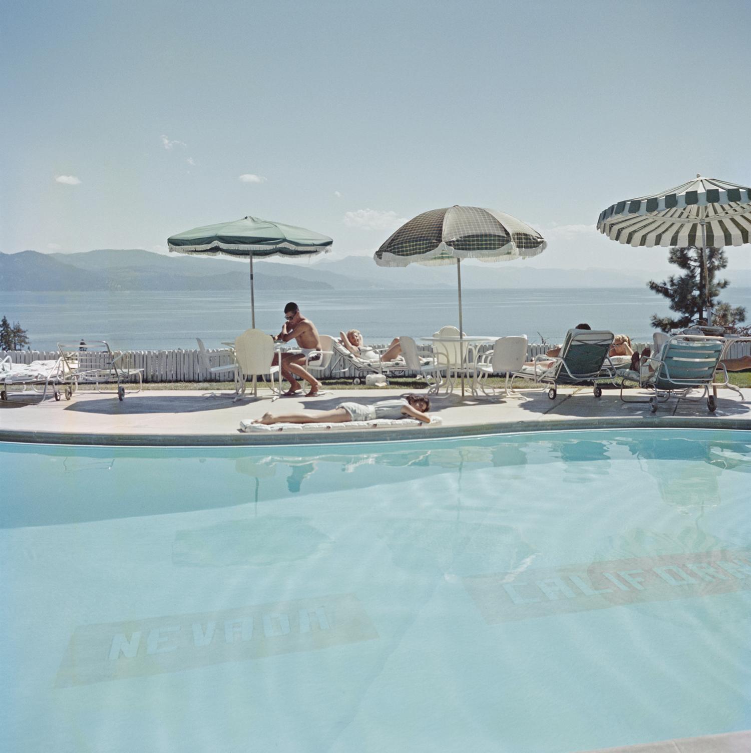' STATE LINE ' 1959 by Slim Aarons

ESTATE EDITION -

numbered and emboss stamped on front. (edition size 150 only)


State Line
A swimming pool at the Cal Neva Lodge on the shore of Lake Tahoe, 1959. The Cal Neva Lodge straddles the border between