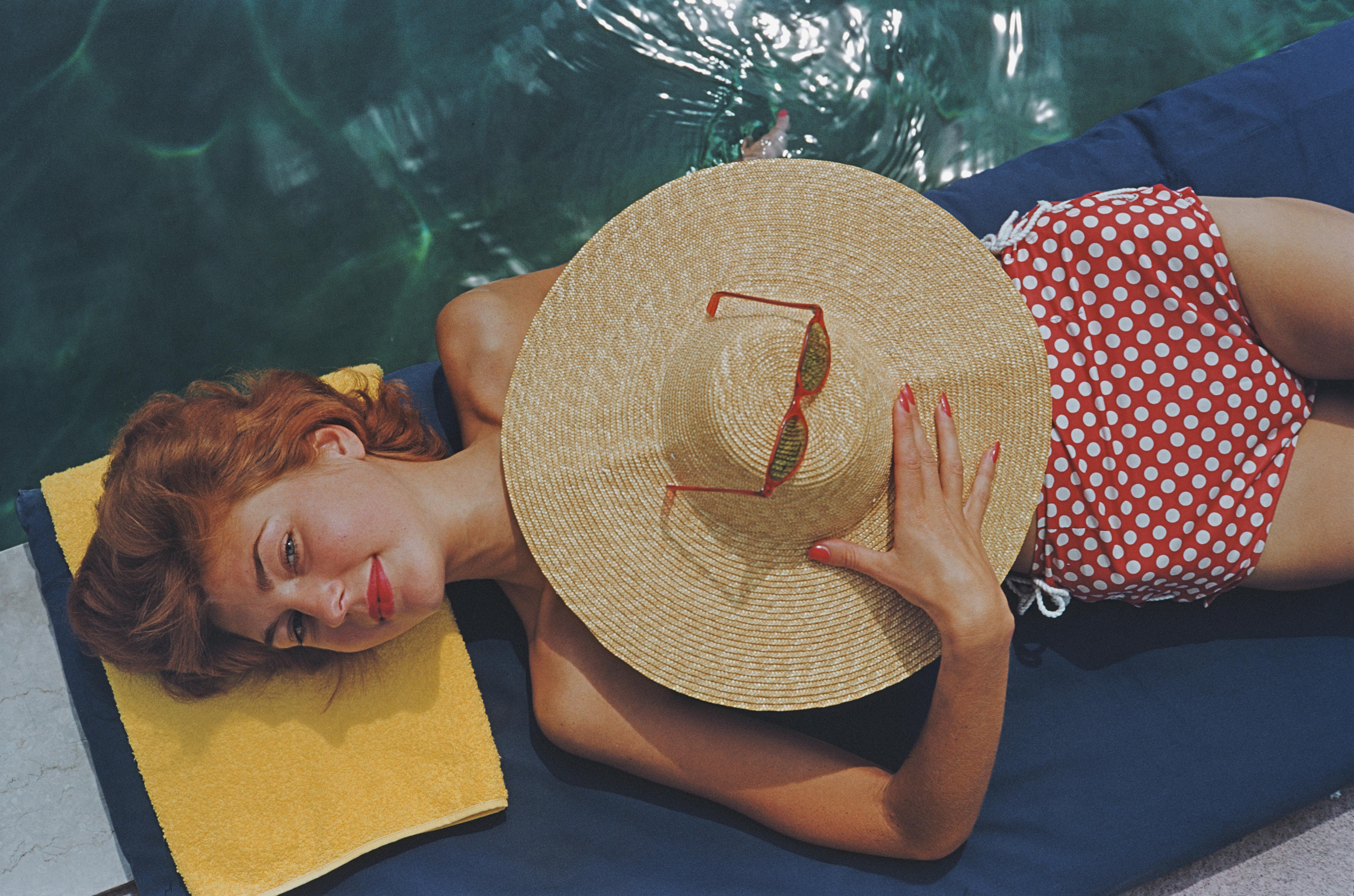 Slim Aarons
Coral Beach, Bermuda, 1977. 
C print
estate edition of 150
Estate stamped and hand numbered edition of 150 with certificate of authenticity from the estate.   

Lilian Hanson, sunbathing by a pool at the Brgenstock Resort in Canton