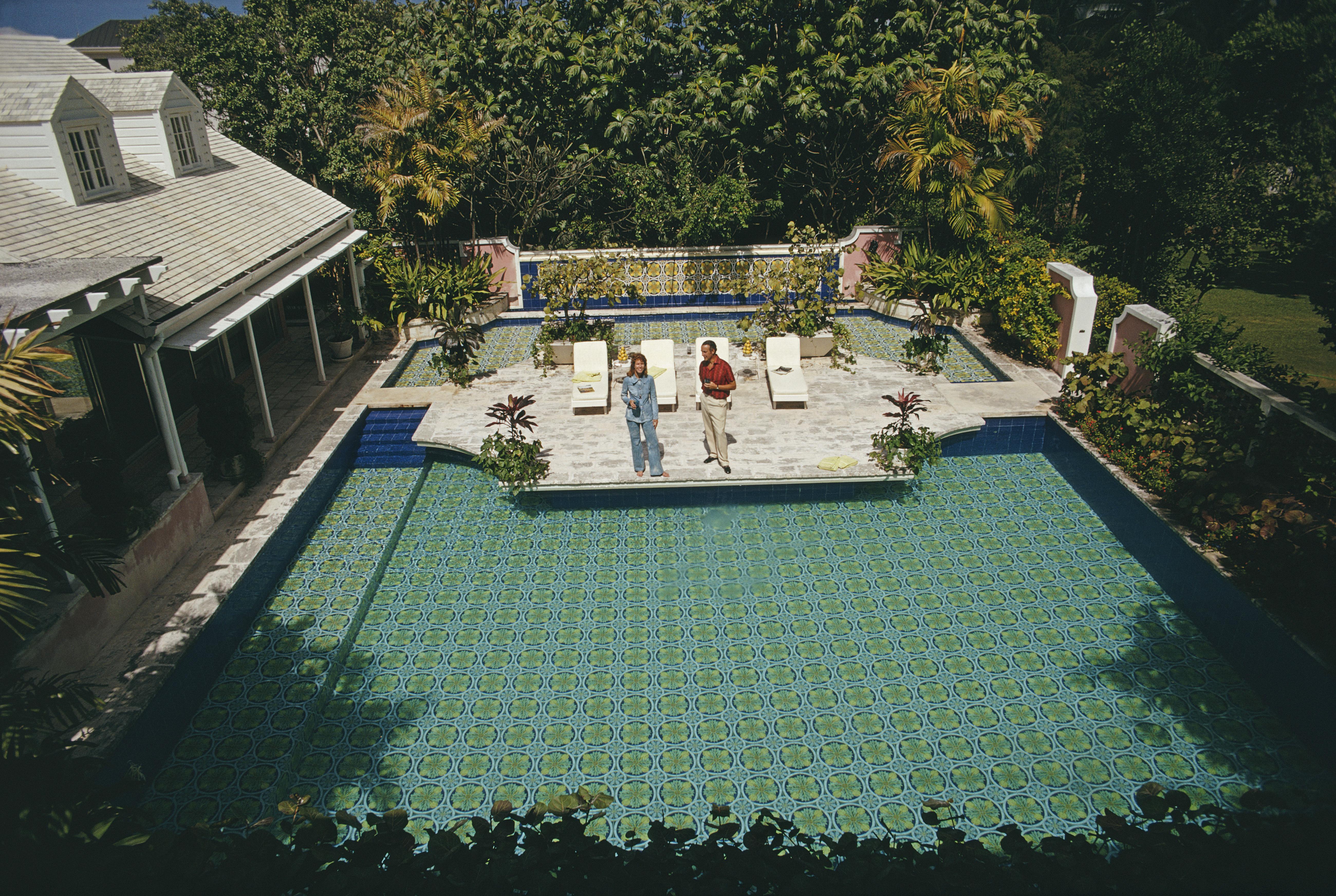 'The Butlers' 1971 Slim Aarons Limited Estate Edition Print 
March 1971: Allan and Shirley Butler beside the pool at their home 'Jacaranda' in the Bahamas. His wife is the daughter of the well known Bahamian, Sir Harry Oakes. 

Slim Aarons